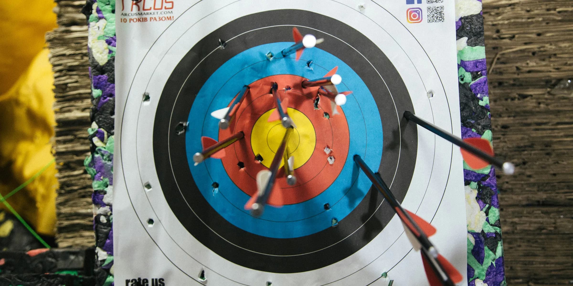 a close up of a target with arrows in it
