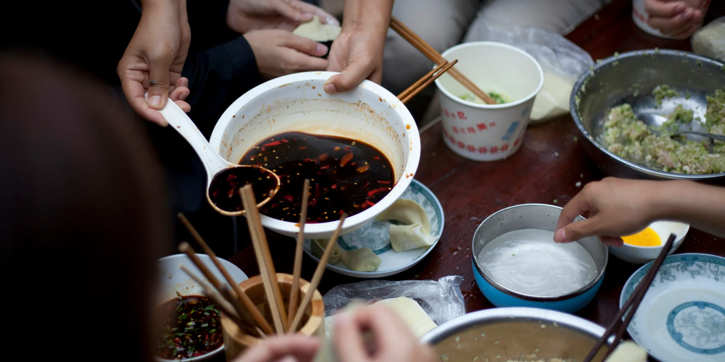 people eating using chopsticks