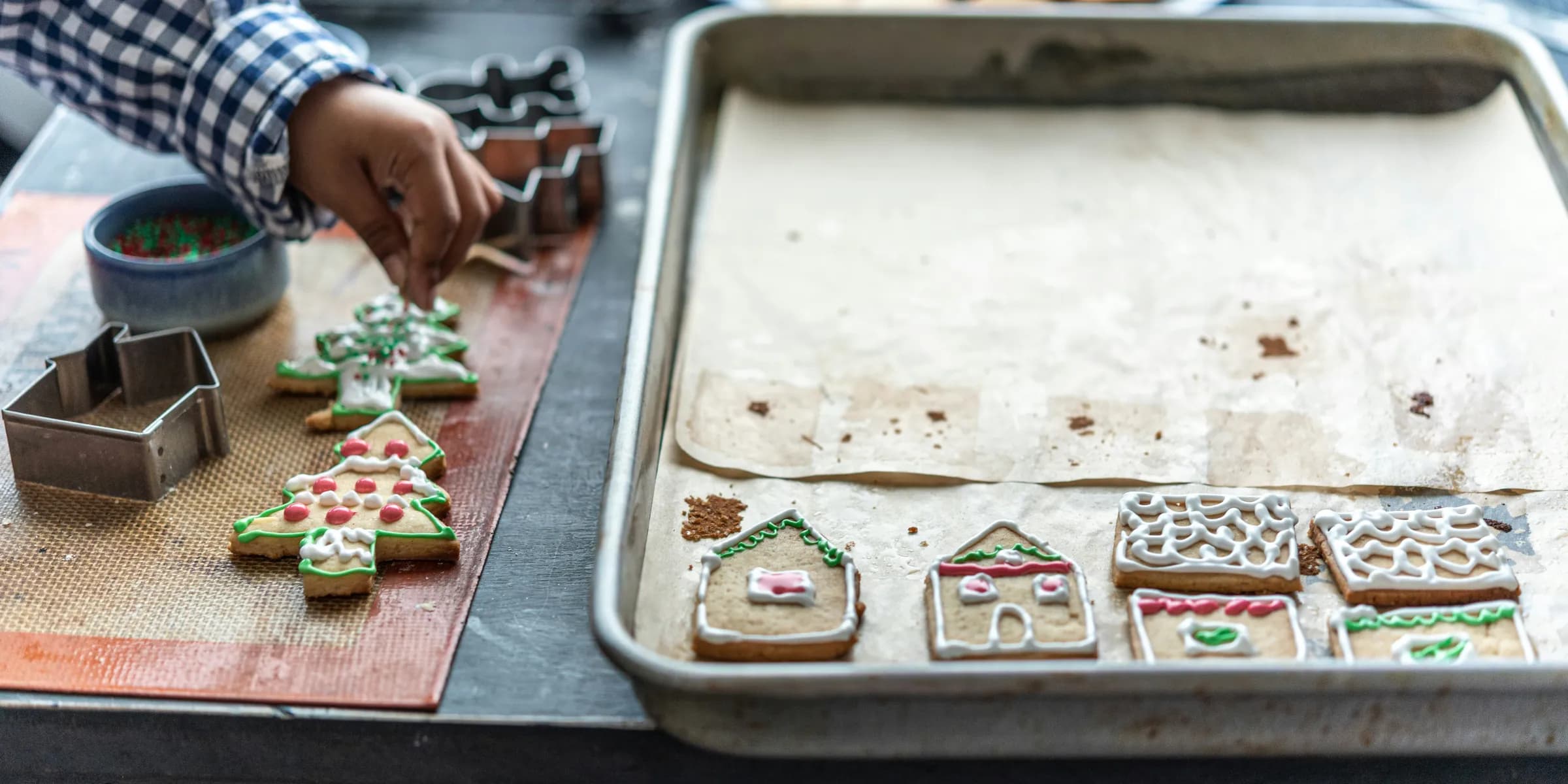 a person decorating cookies on a table