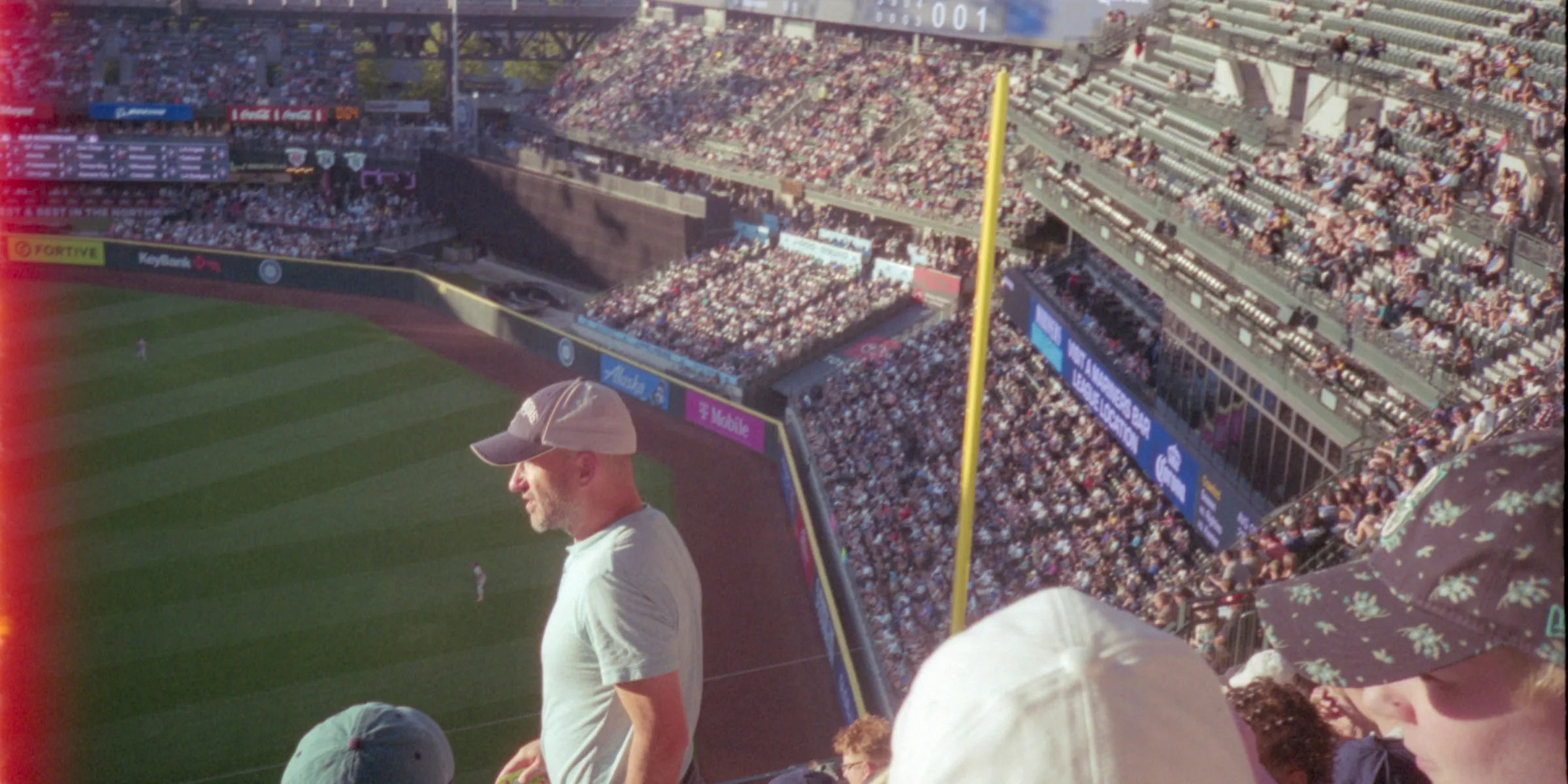 Fans watch a baseball game from the stands.