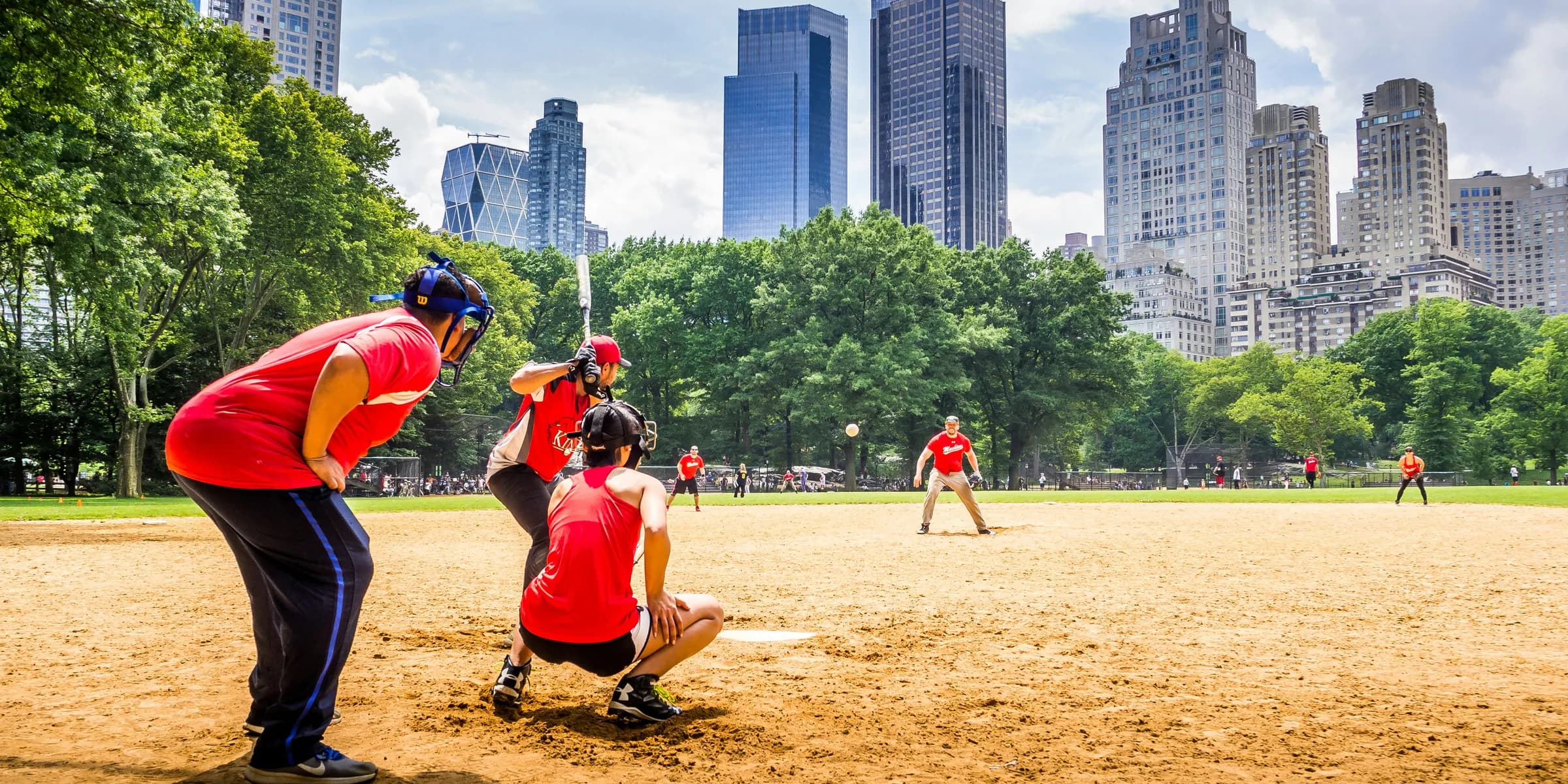 group of people playing baseball at daytime