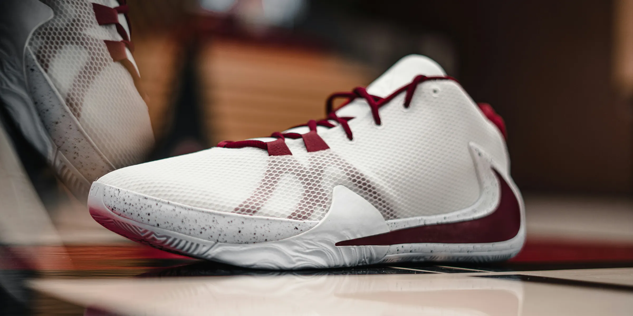 white and red nike athletic shoes