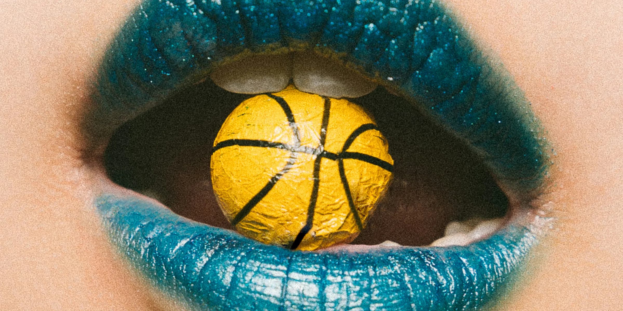 person wearing blue lipstick about to eat basketball candy