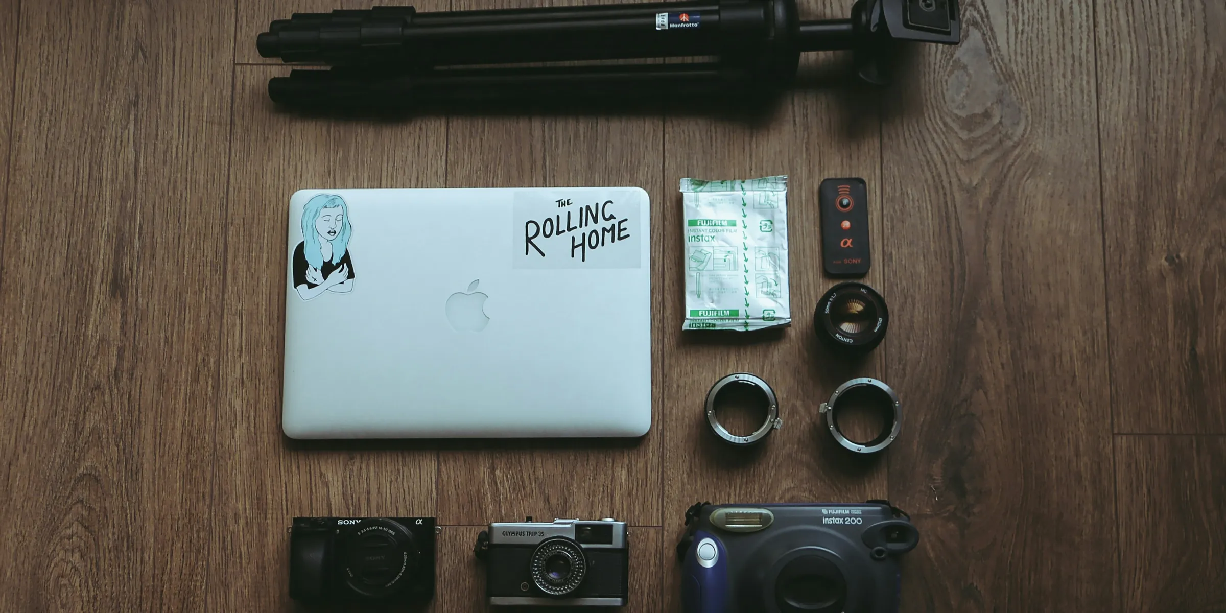 A table with a laptop, camera, and other items on it
