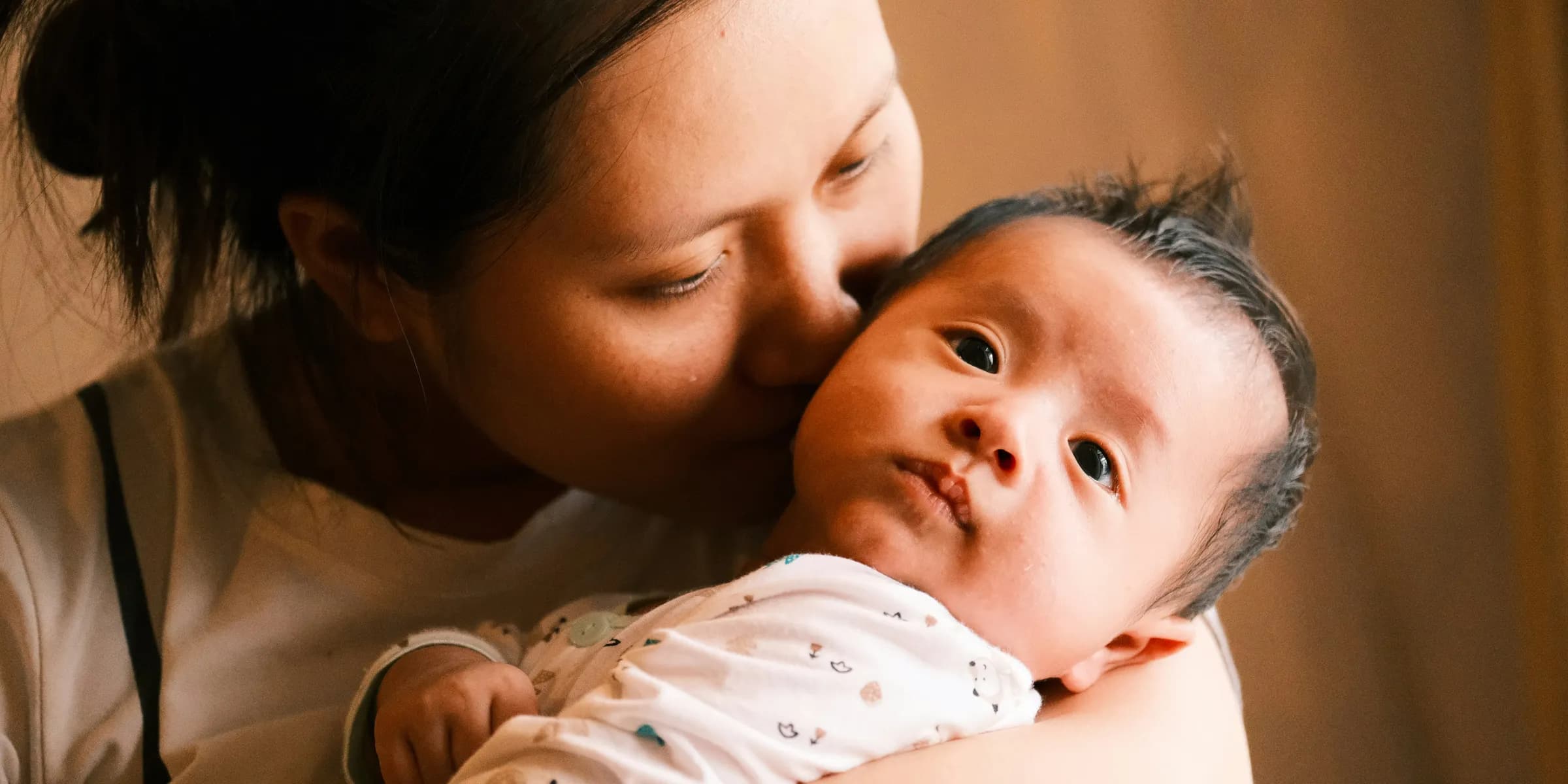 a woman holding a baby in her arms