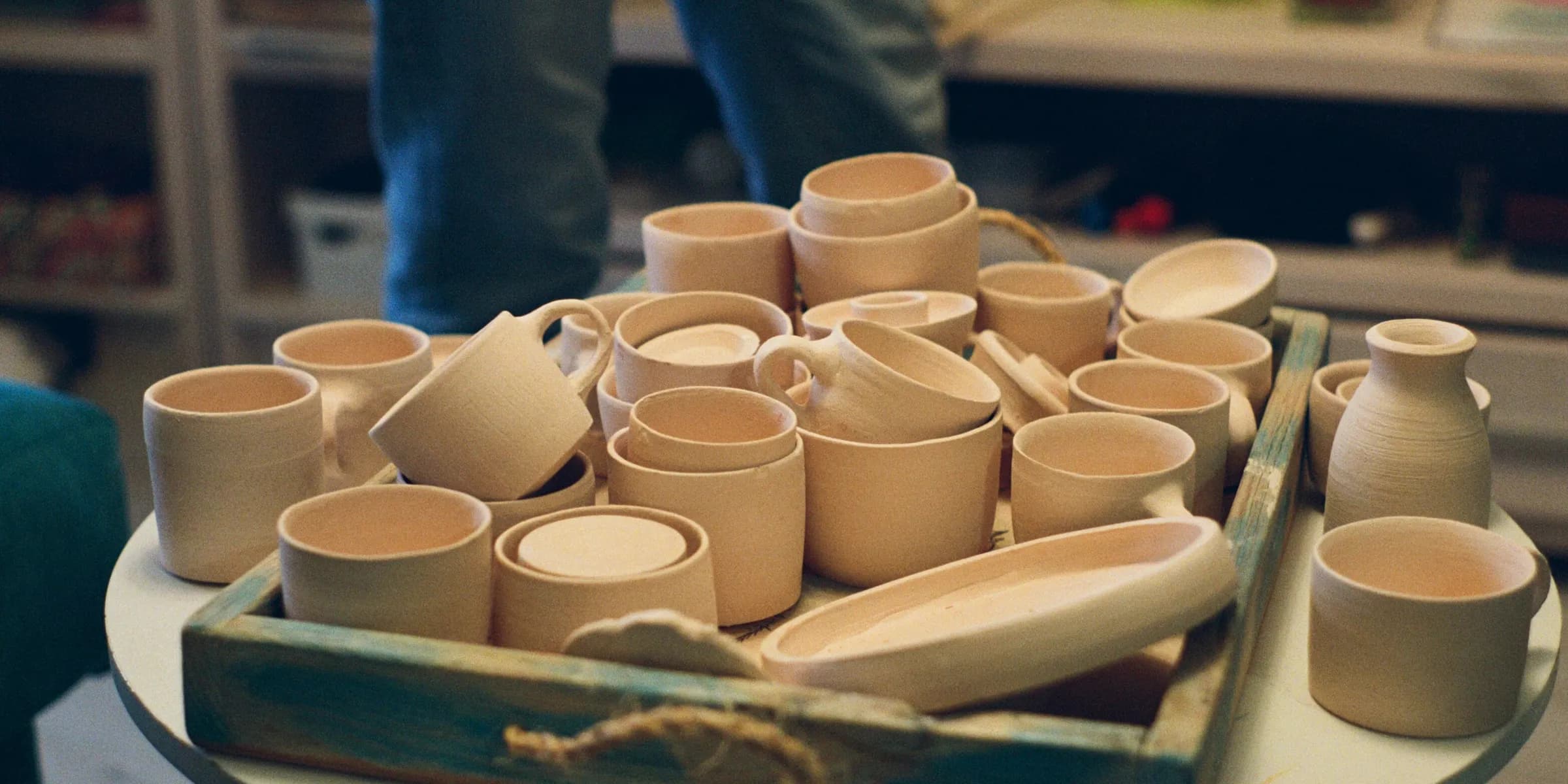 a tray of pottery sitting on top of a table