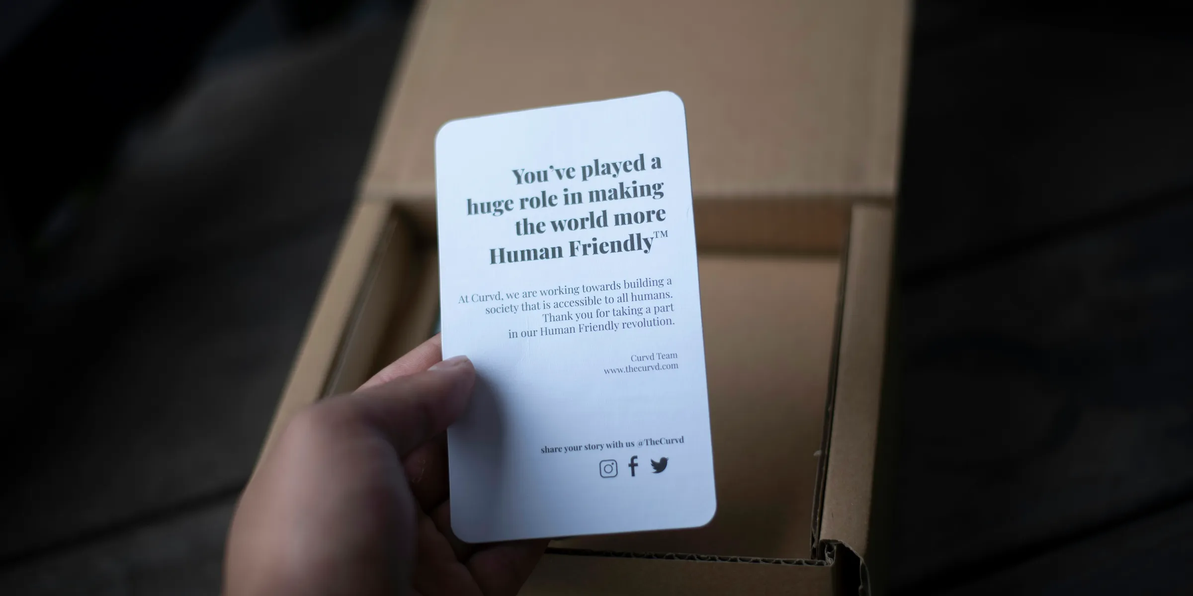 a person is holding a card in a box