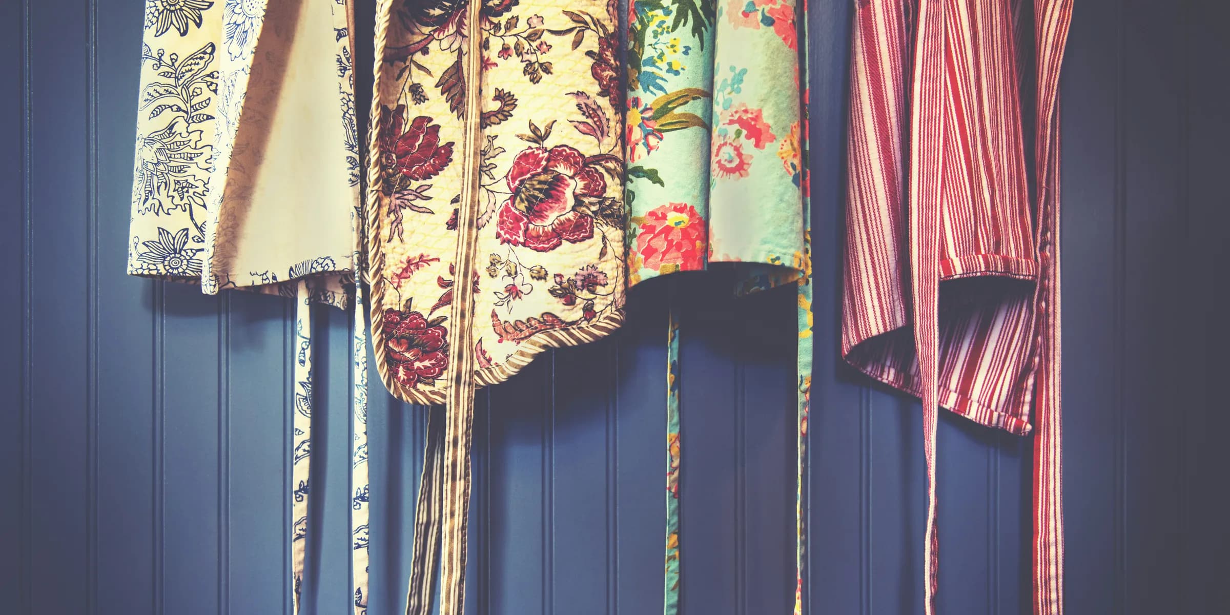 four assorted-color aprons