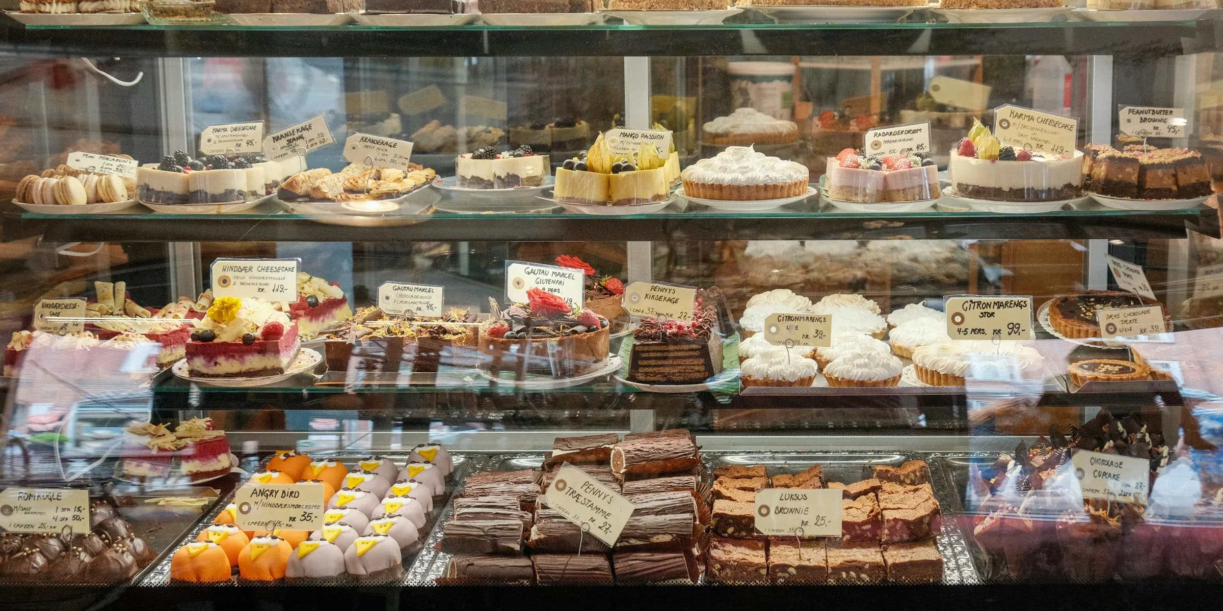 a display case filled with lots of different types of cakes