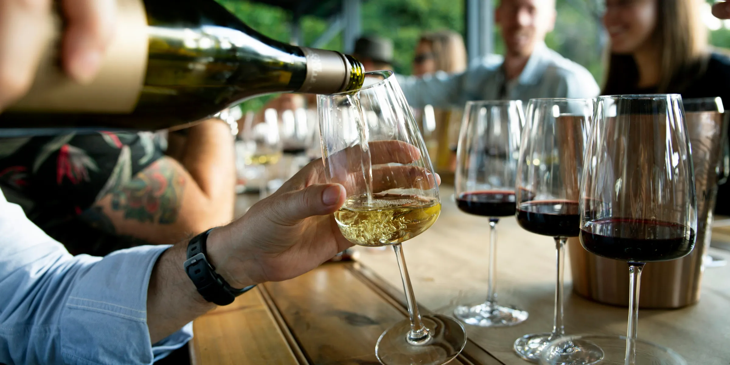 a group of people sitting at a table with wine glasses