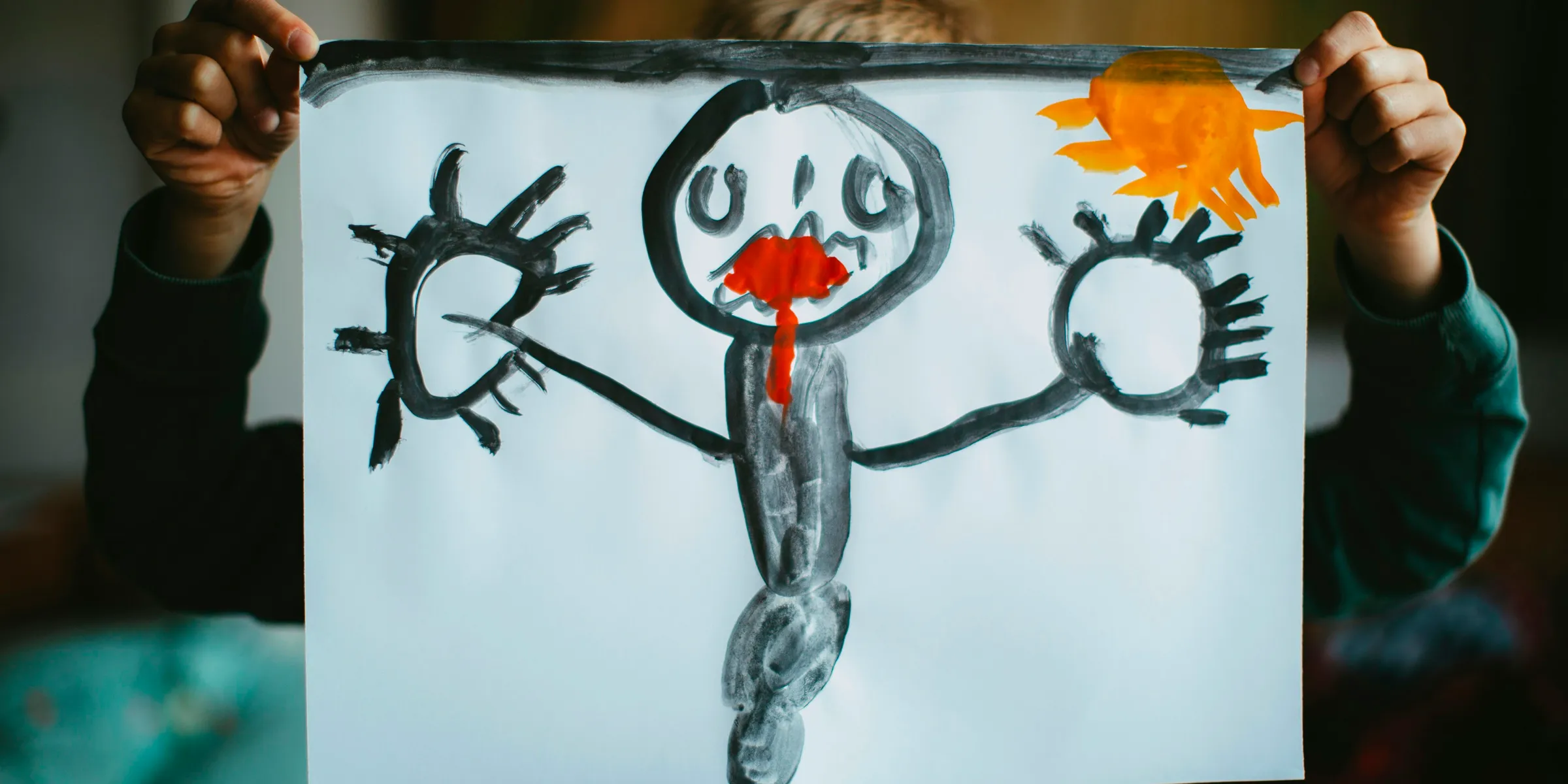 toddler holding drawing