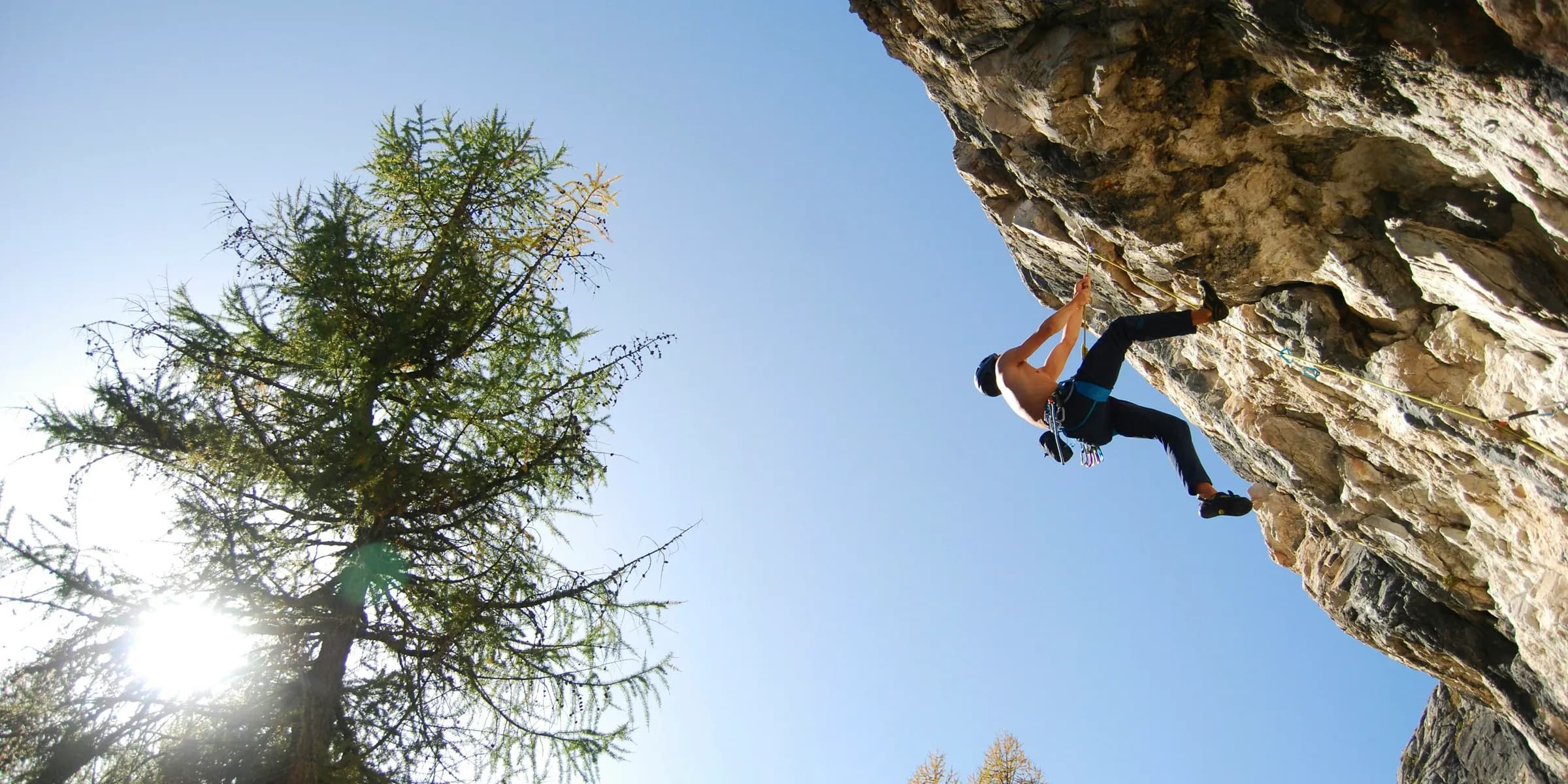 a man climbing up the side of a cliff