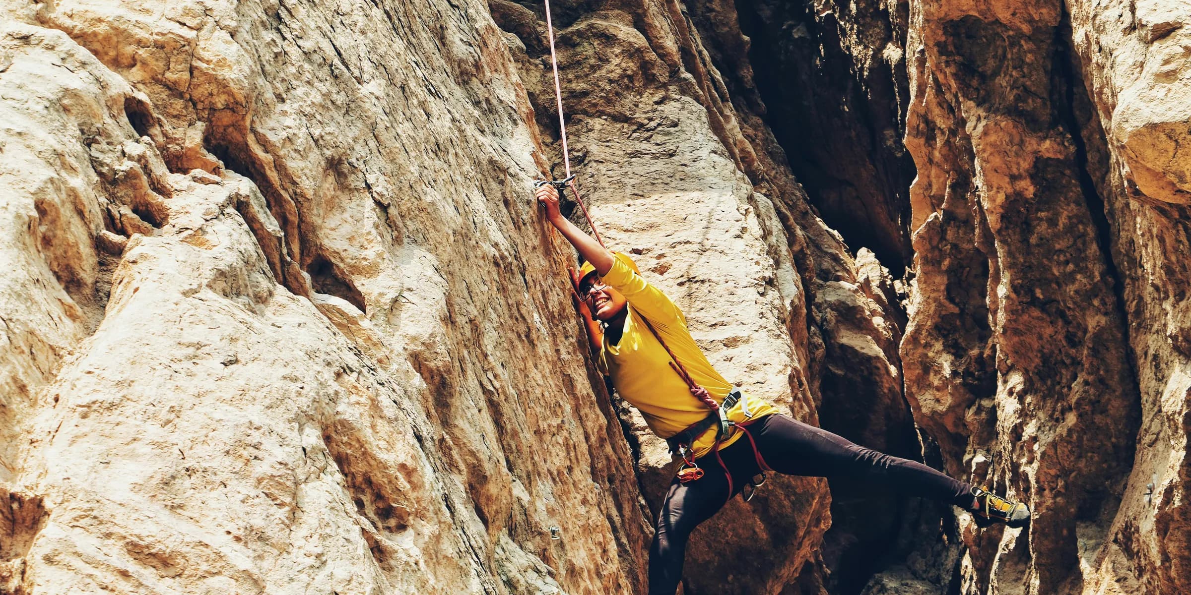 person climbing on the rock