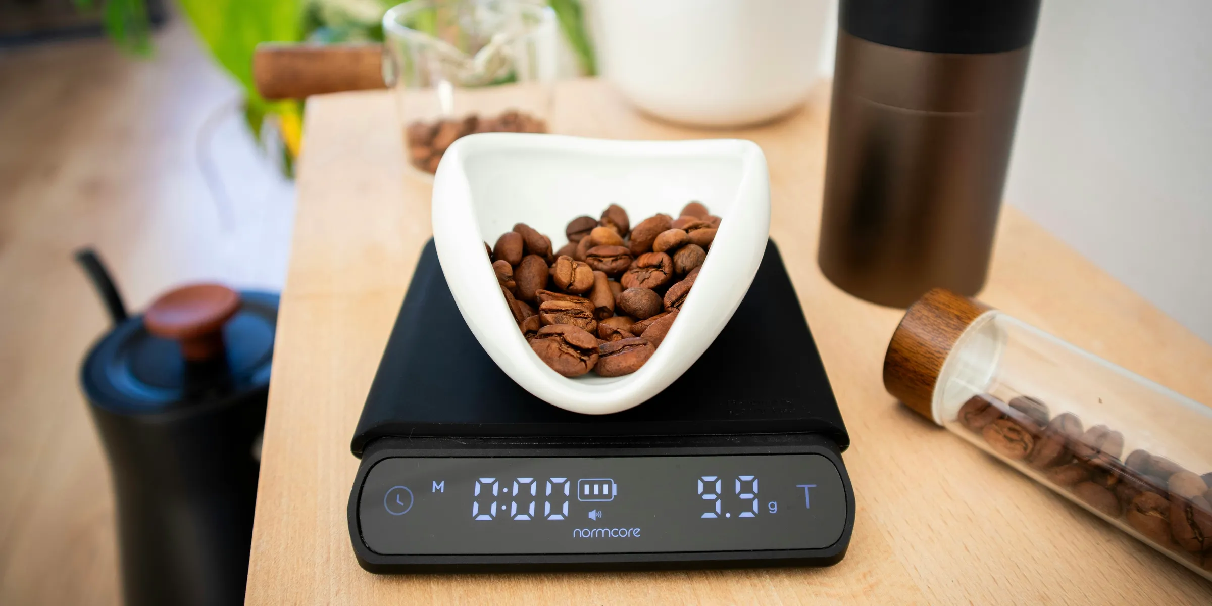 Coffee beans are being weighed on a digital scale.