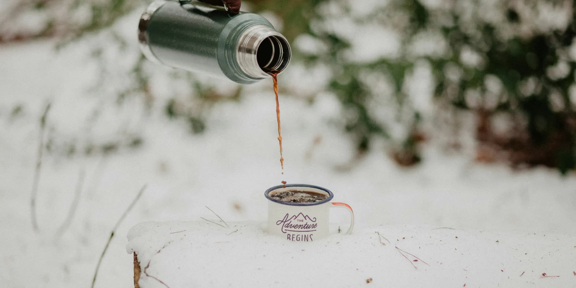 depth photo of person holding vacuum flask filling cup