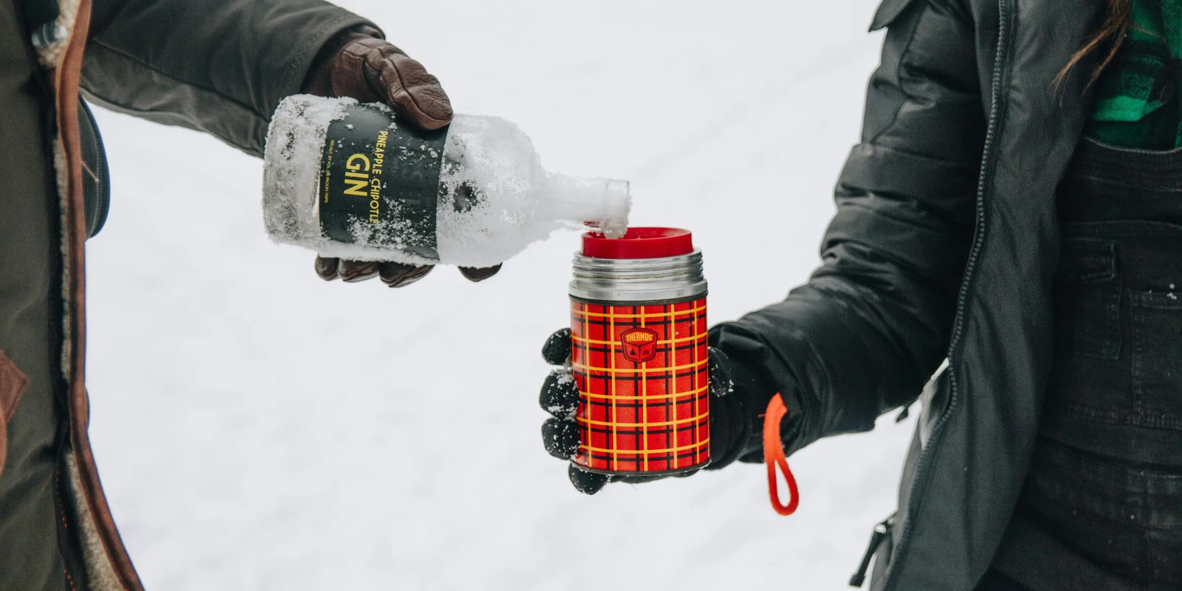men pouring water on cup