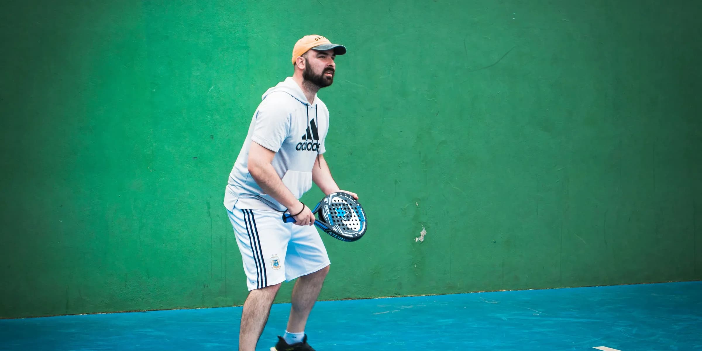 a man holding a tennis racquet on a tennis court