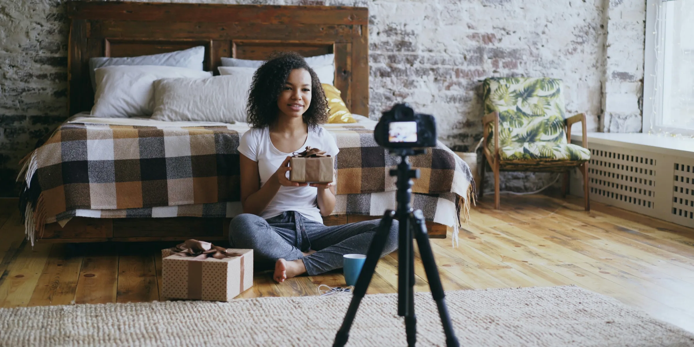 Woman unboxing gifts in front of camera