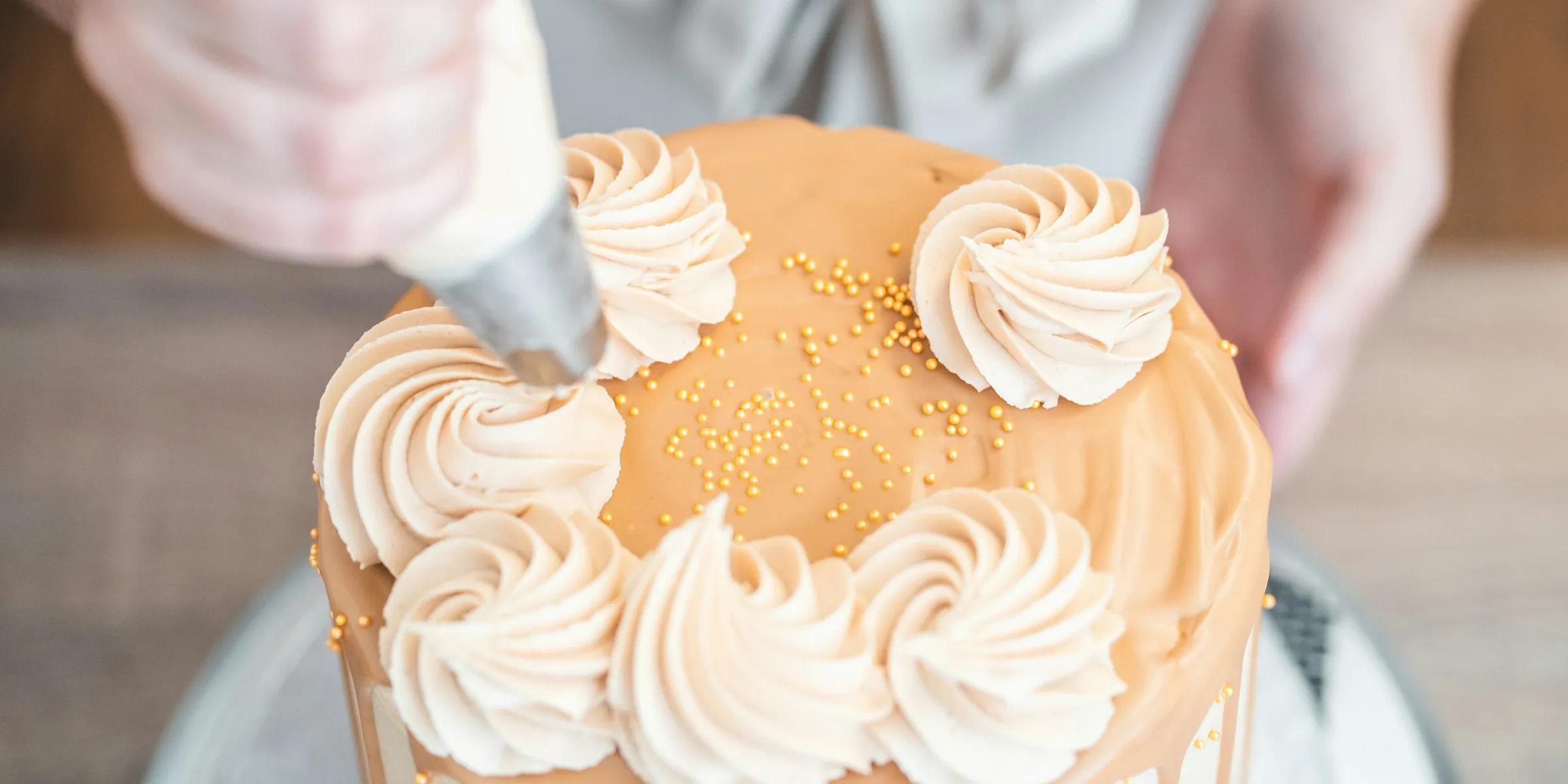 a person cutting a cake with a knife