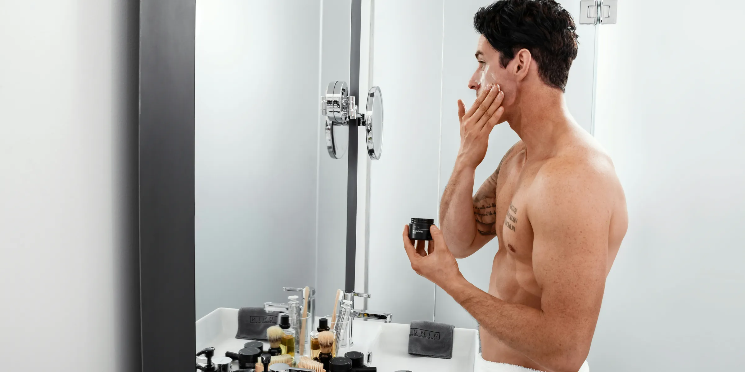 topless man standing beside sink
