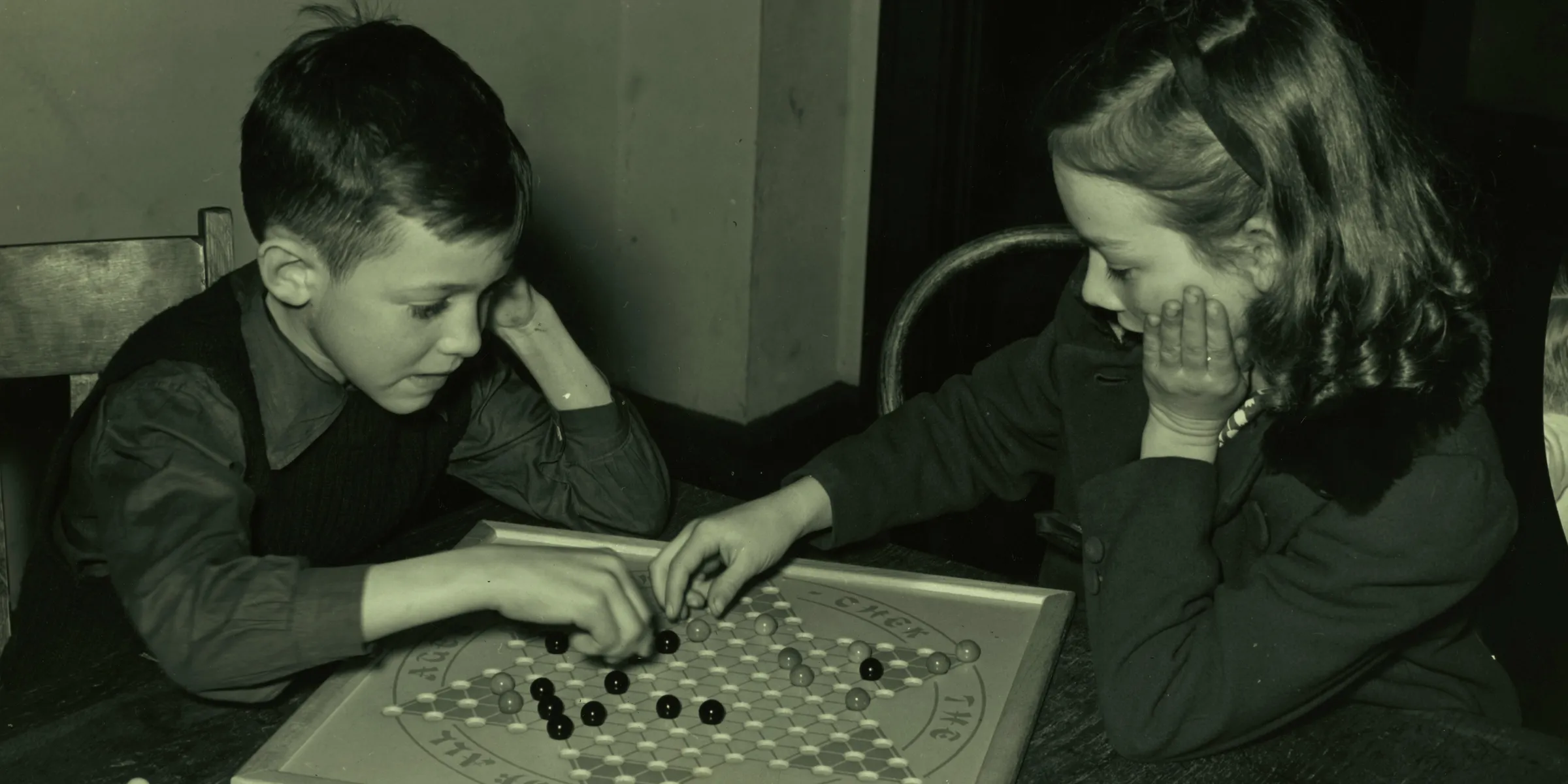 girl and boy playing chess board