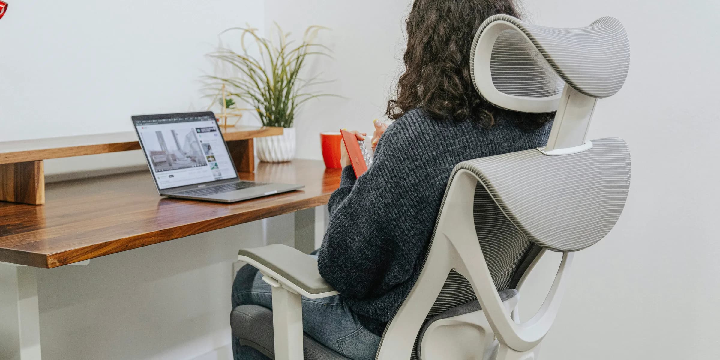 a woman sitting at a desk with a laptop
