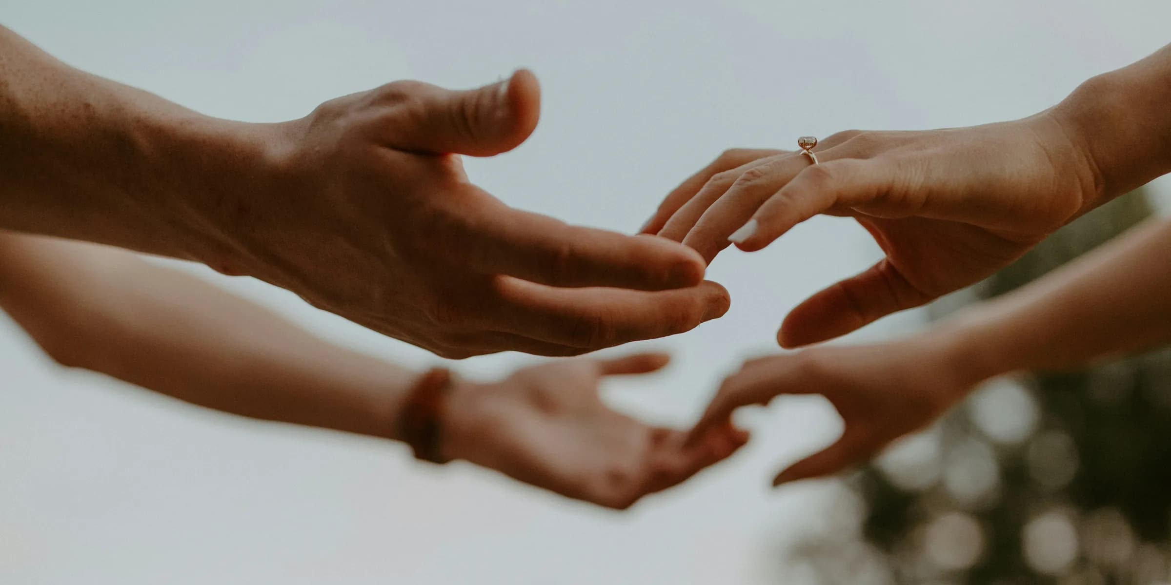 a group of people reaching out their hands