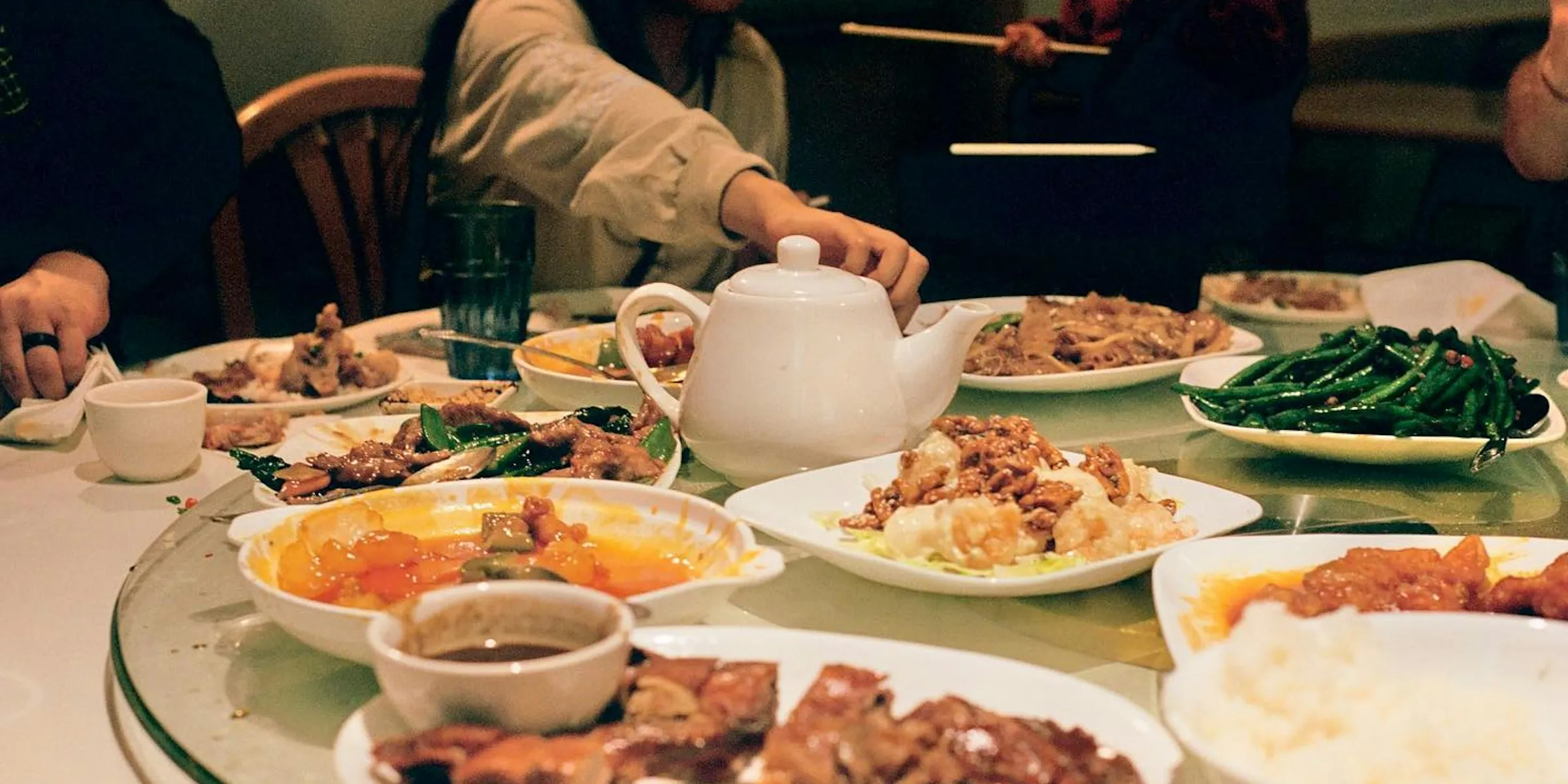 A group of people sitting around a table full of food