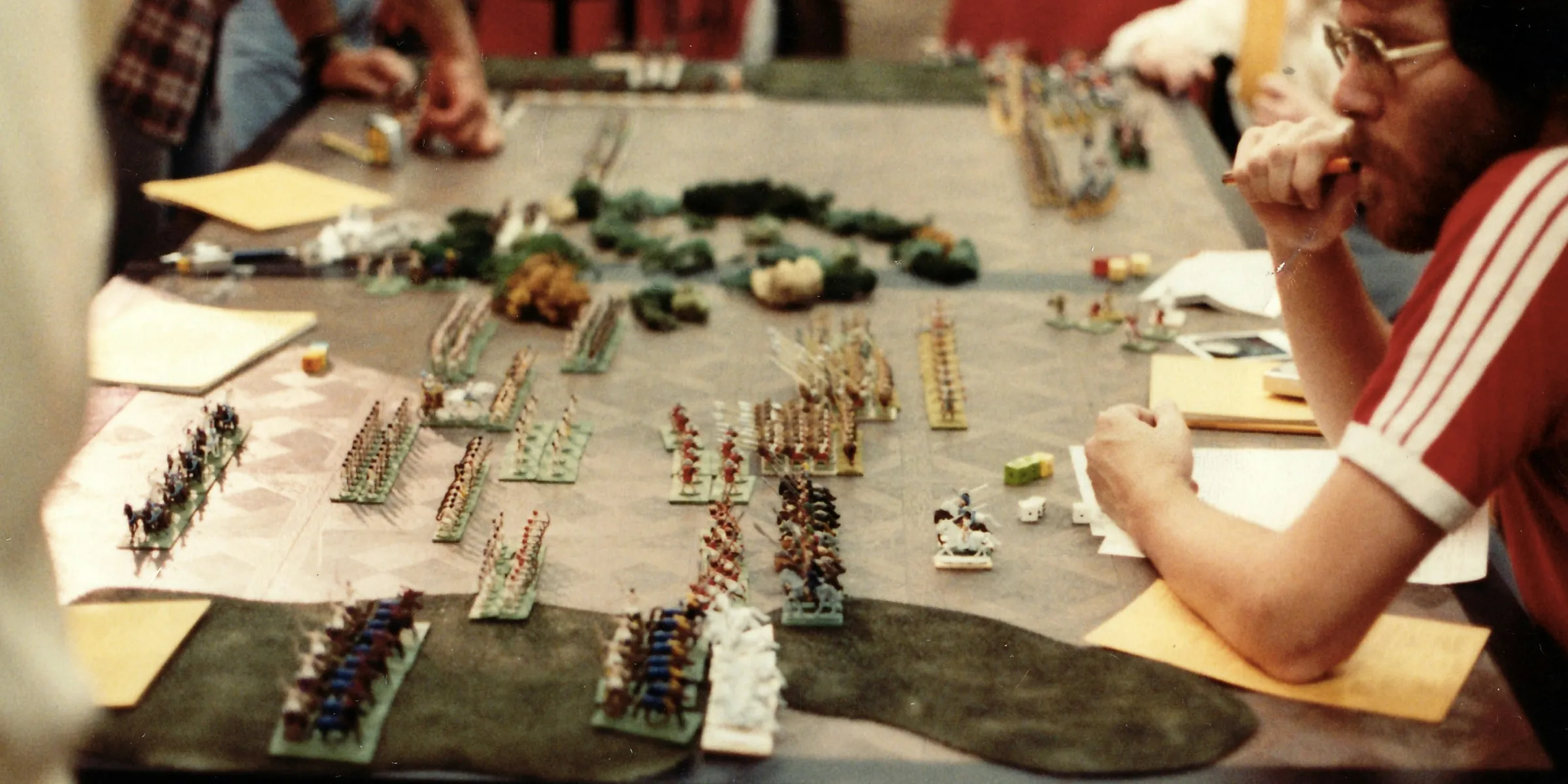 a group of people sitting around a table playing a game