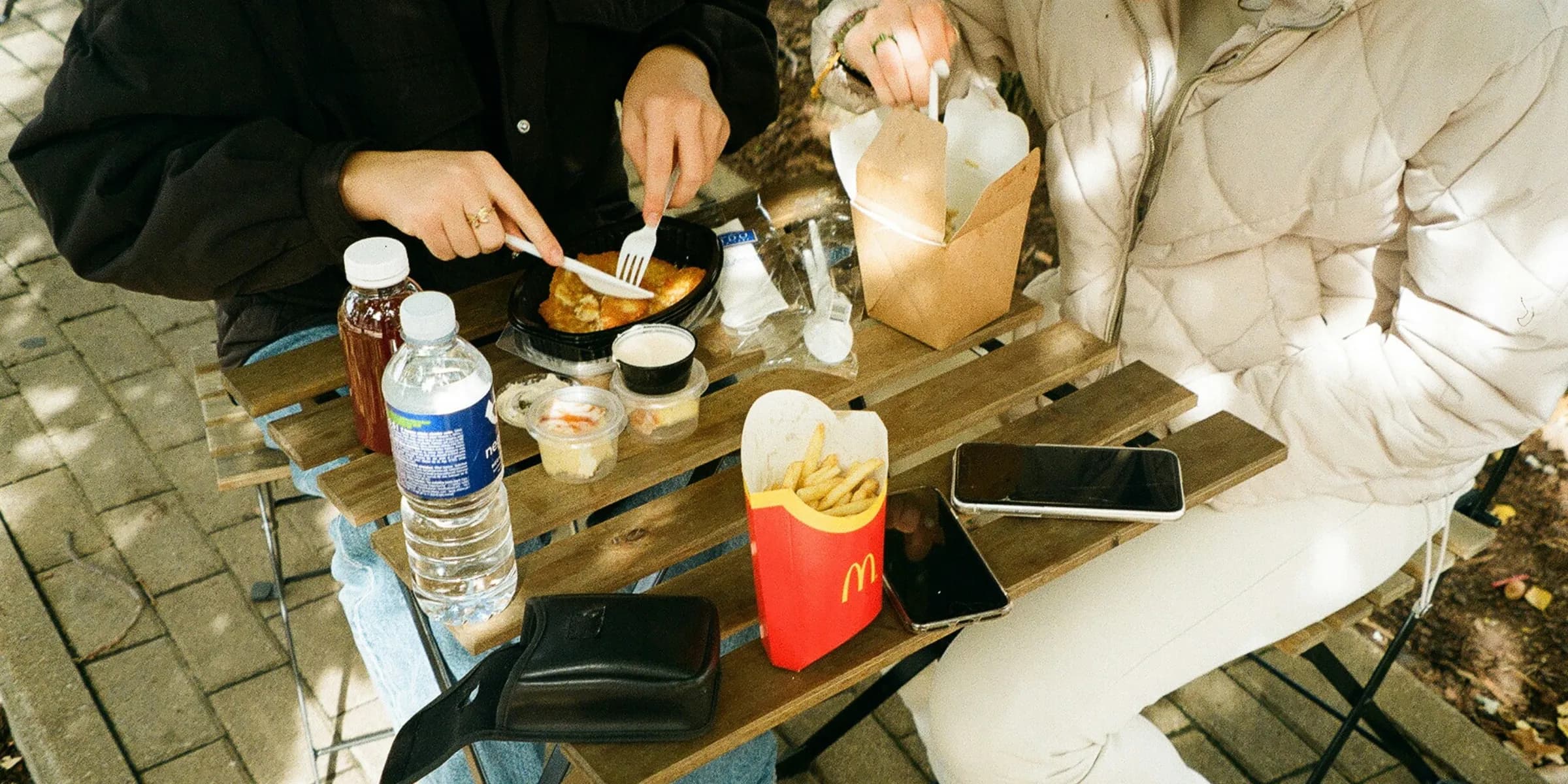 a man and a woman sitting at a table eating food