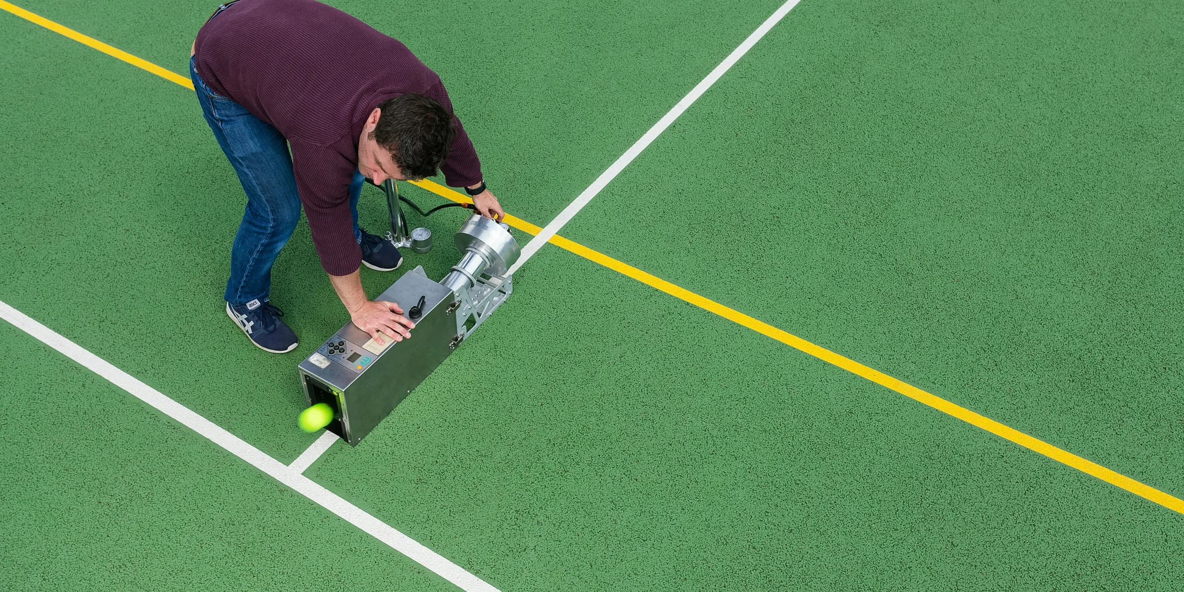 man in red shirt and blue denim jeans playing golf