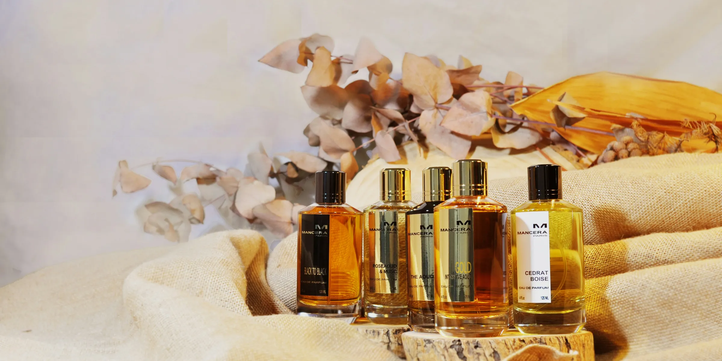 three bottles of cologne sitting on top of a table