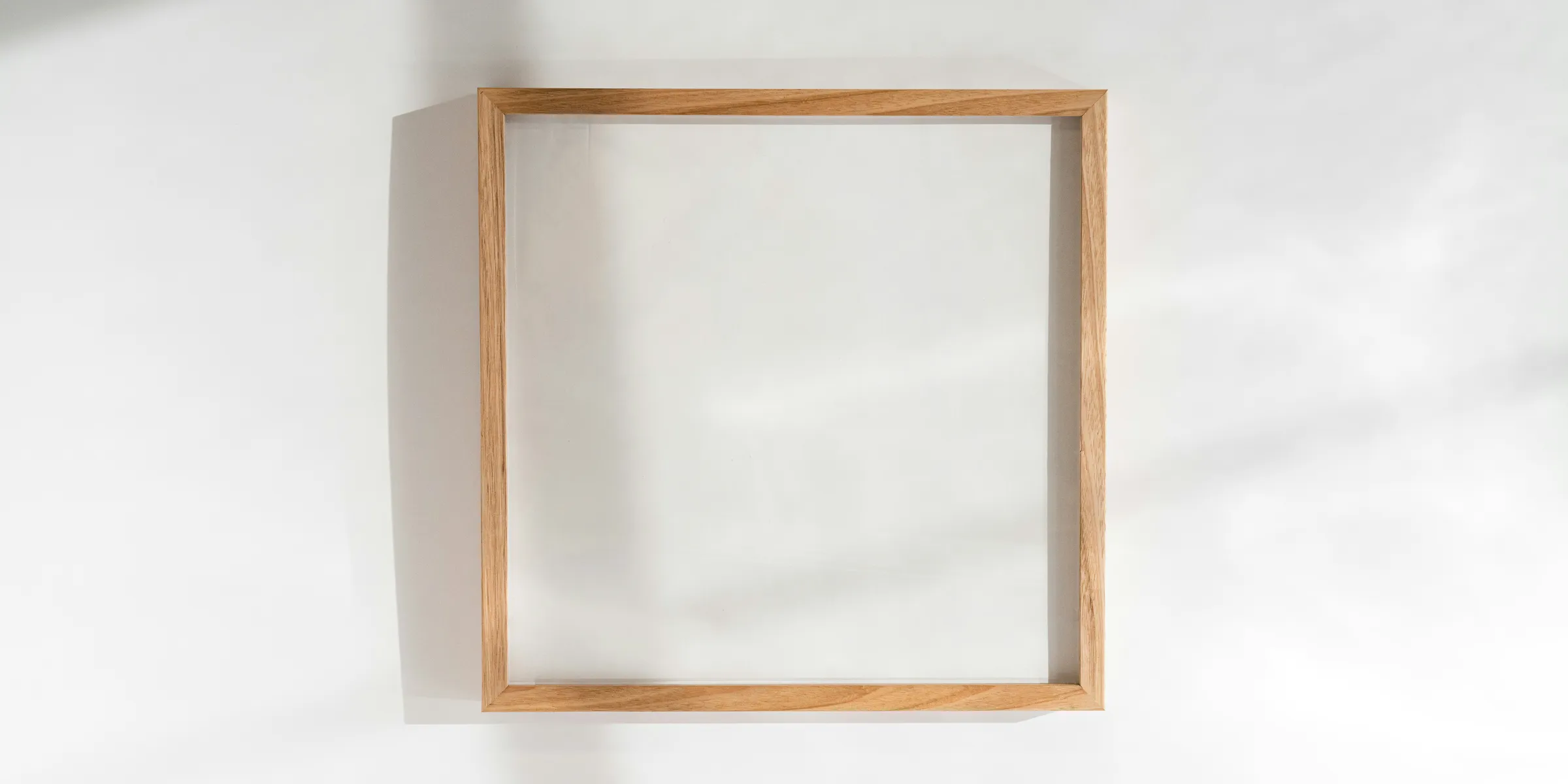 a square wooden frame hanging on a wall