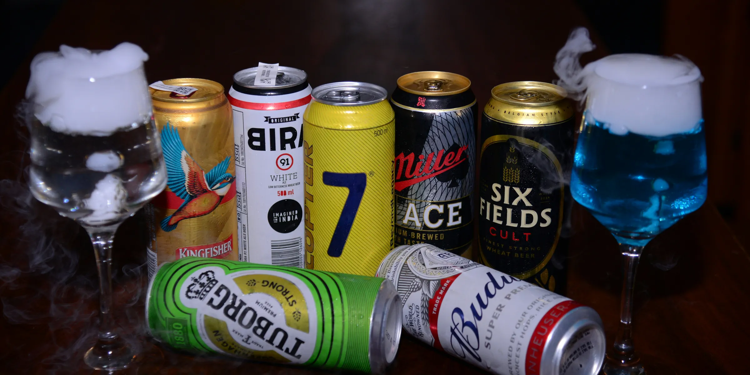 a table topped with lots of different types of drinks