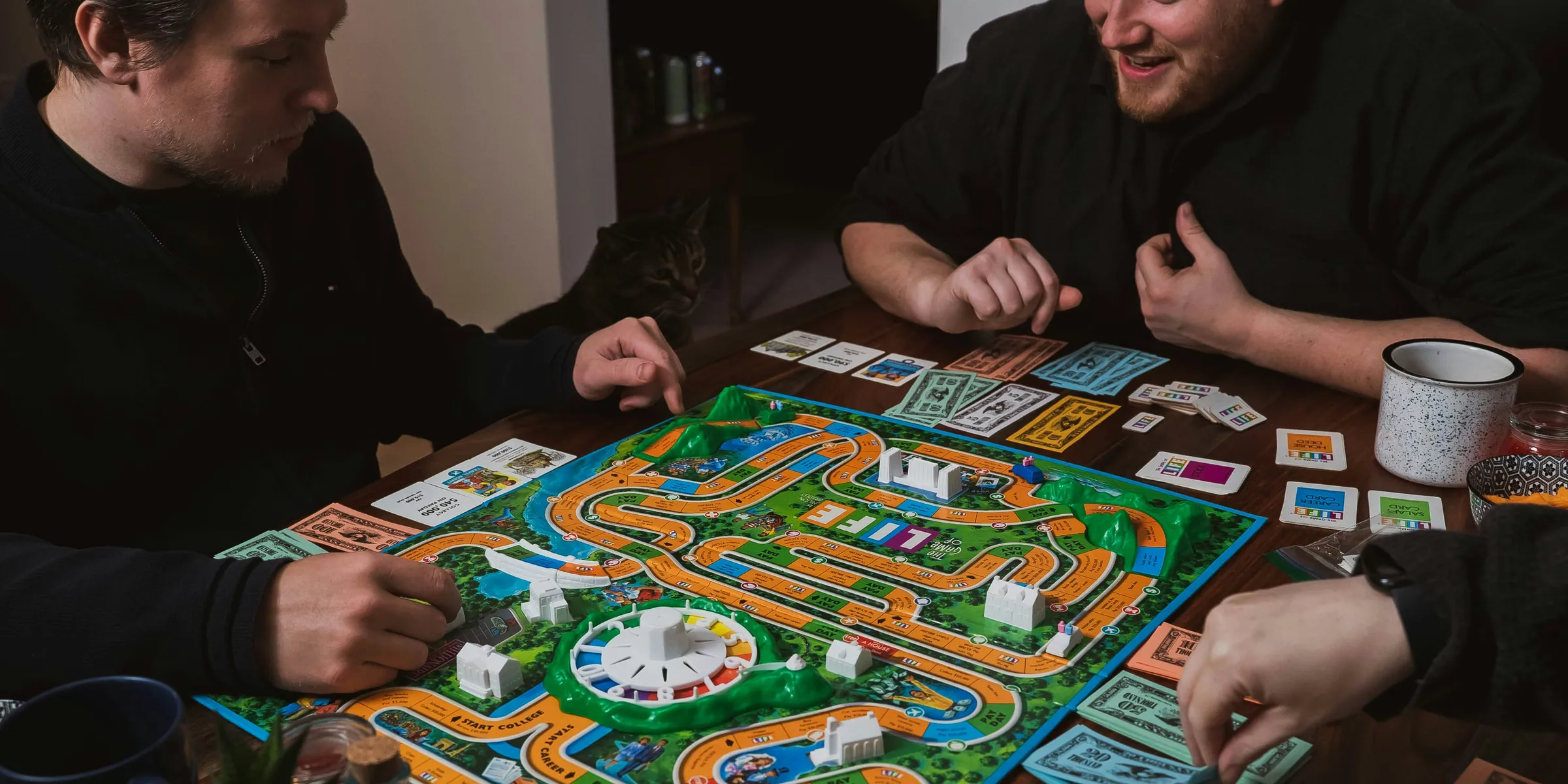 two men playing a game of monopoly on a table
