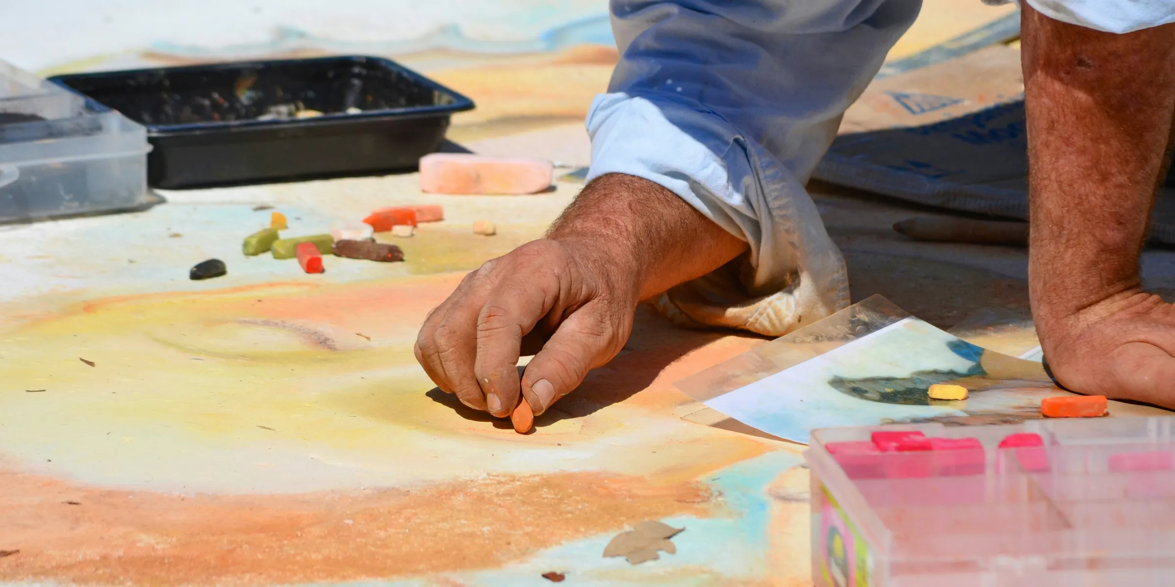 person in white dress shirt painting on white paper