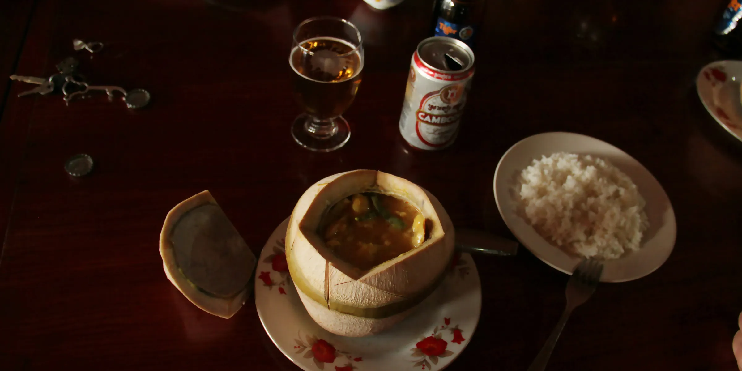 a wooden table topped with plates and bowls of food