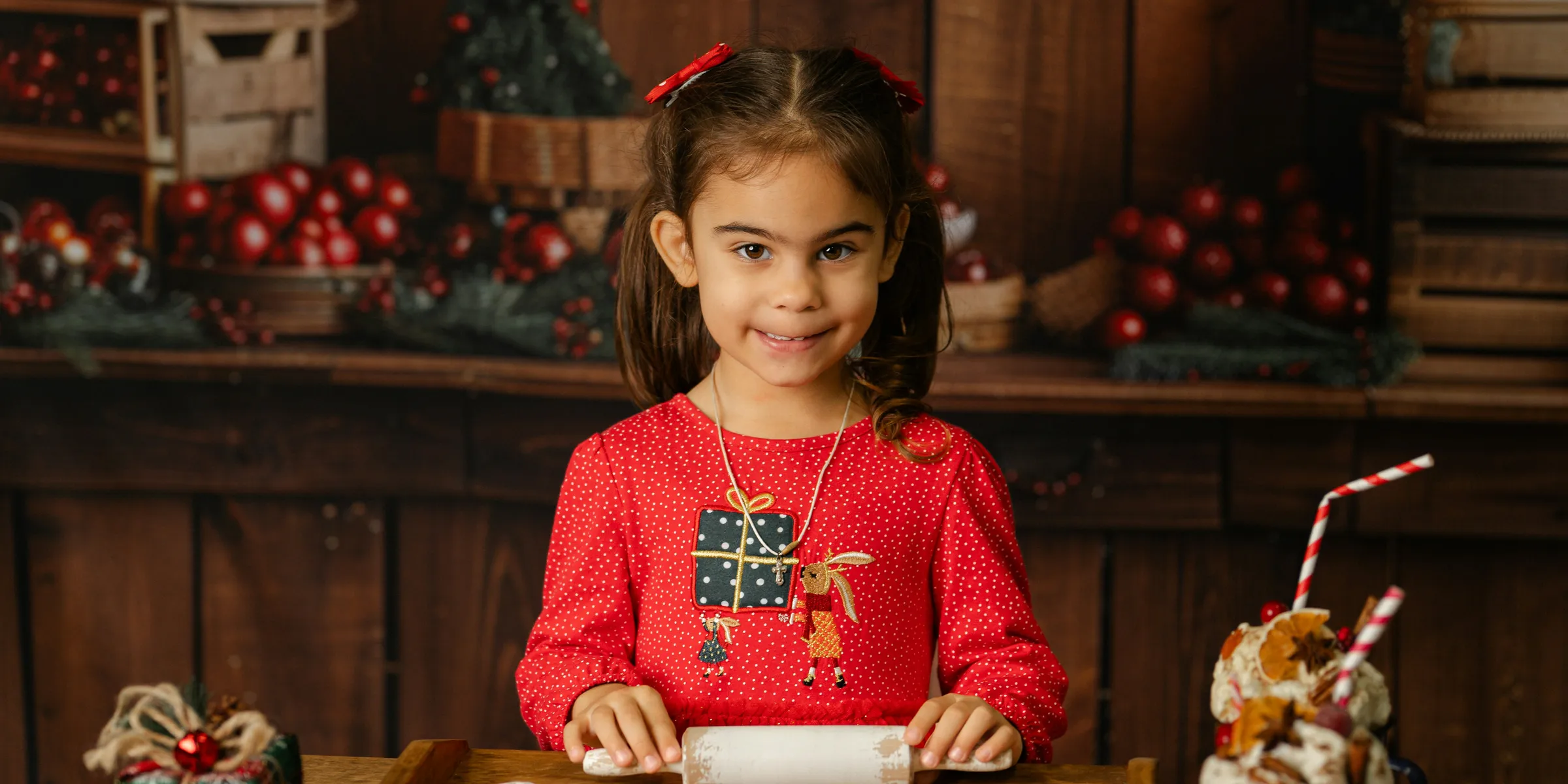 Young girl making christmas cookies with rolling pin