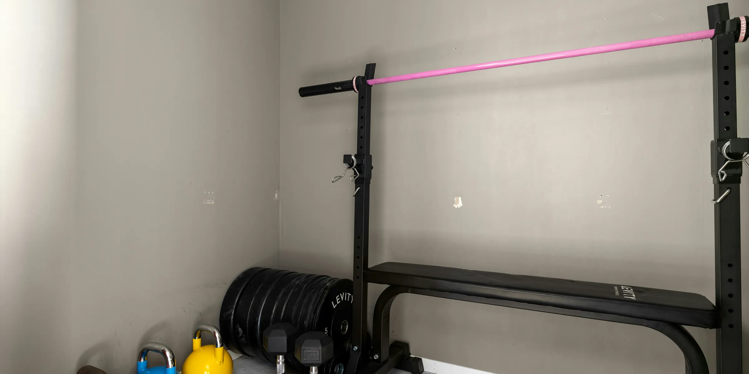 A gym room with a row of exercise equipment