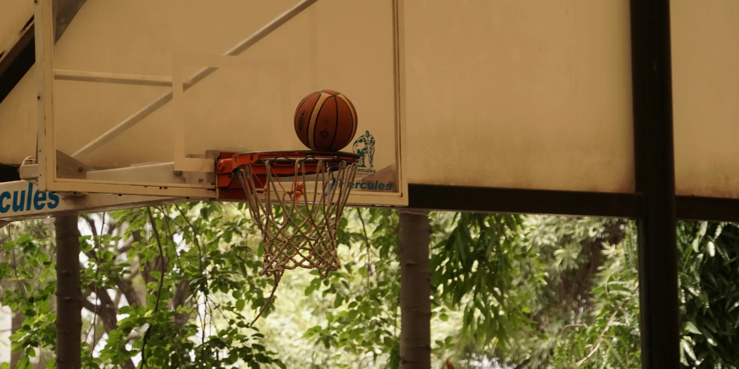 a basketball going through the net of a basketball hoop