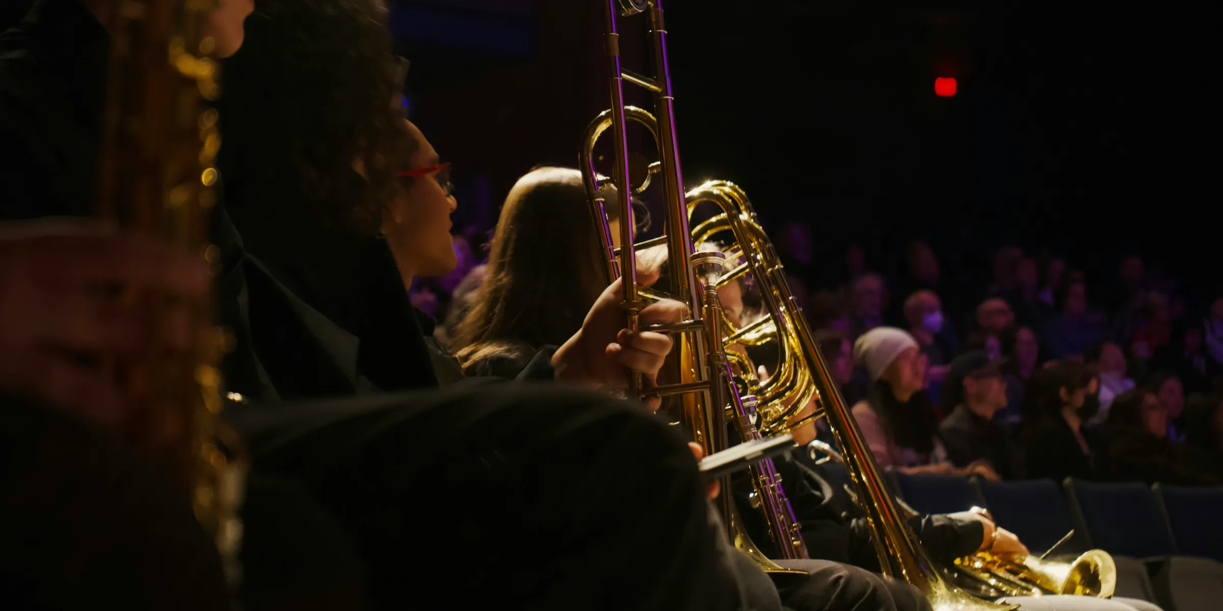 a group of people sitting next to each other in front of a band