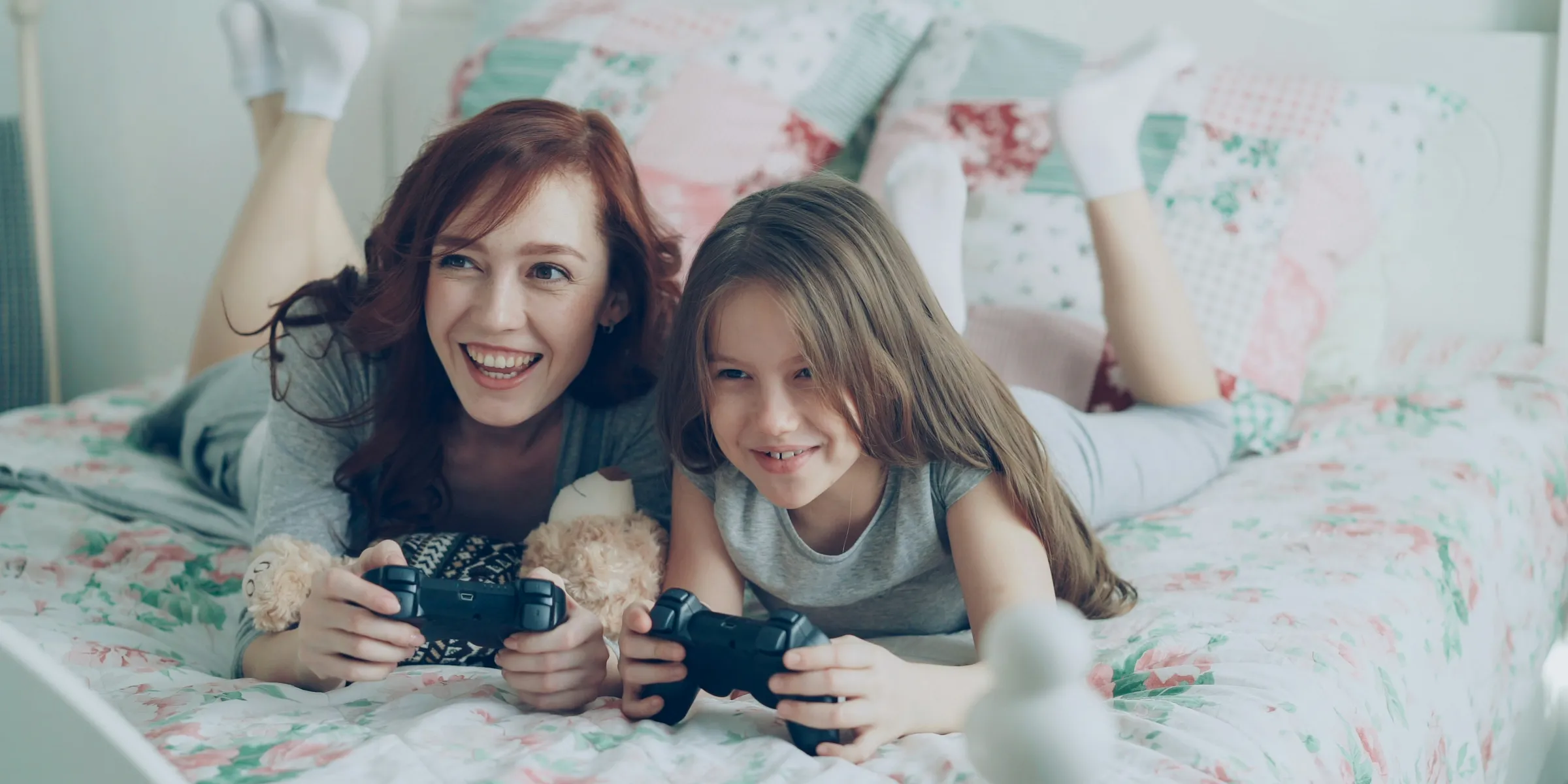 A woman and a child happily play video games.