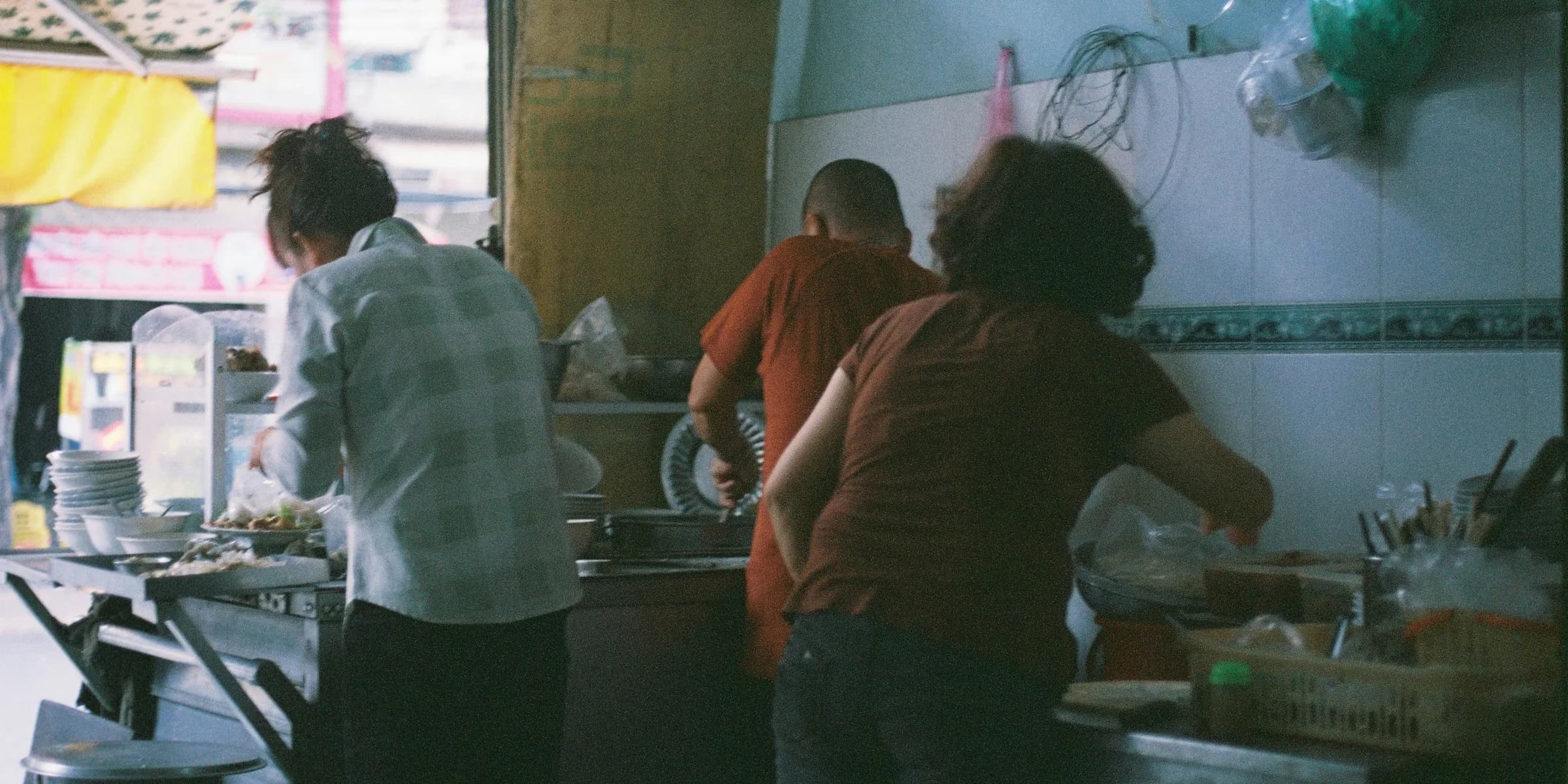 a group of people in a kitchen preparing food