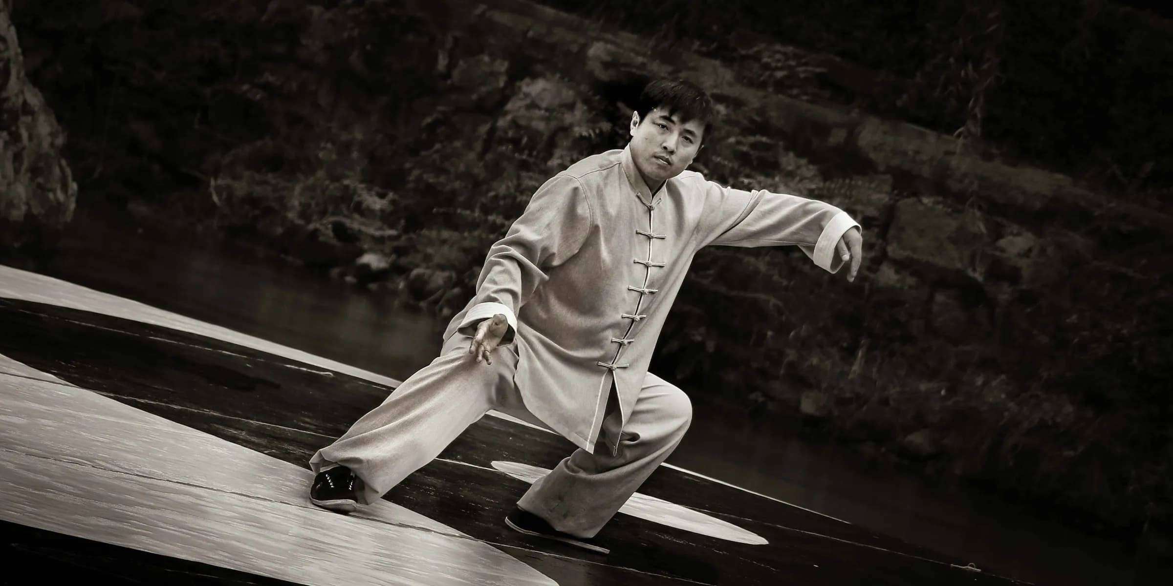 A person practicing kung fu in black and white image