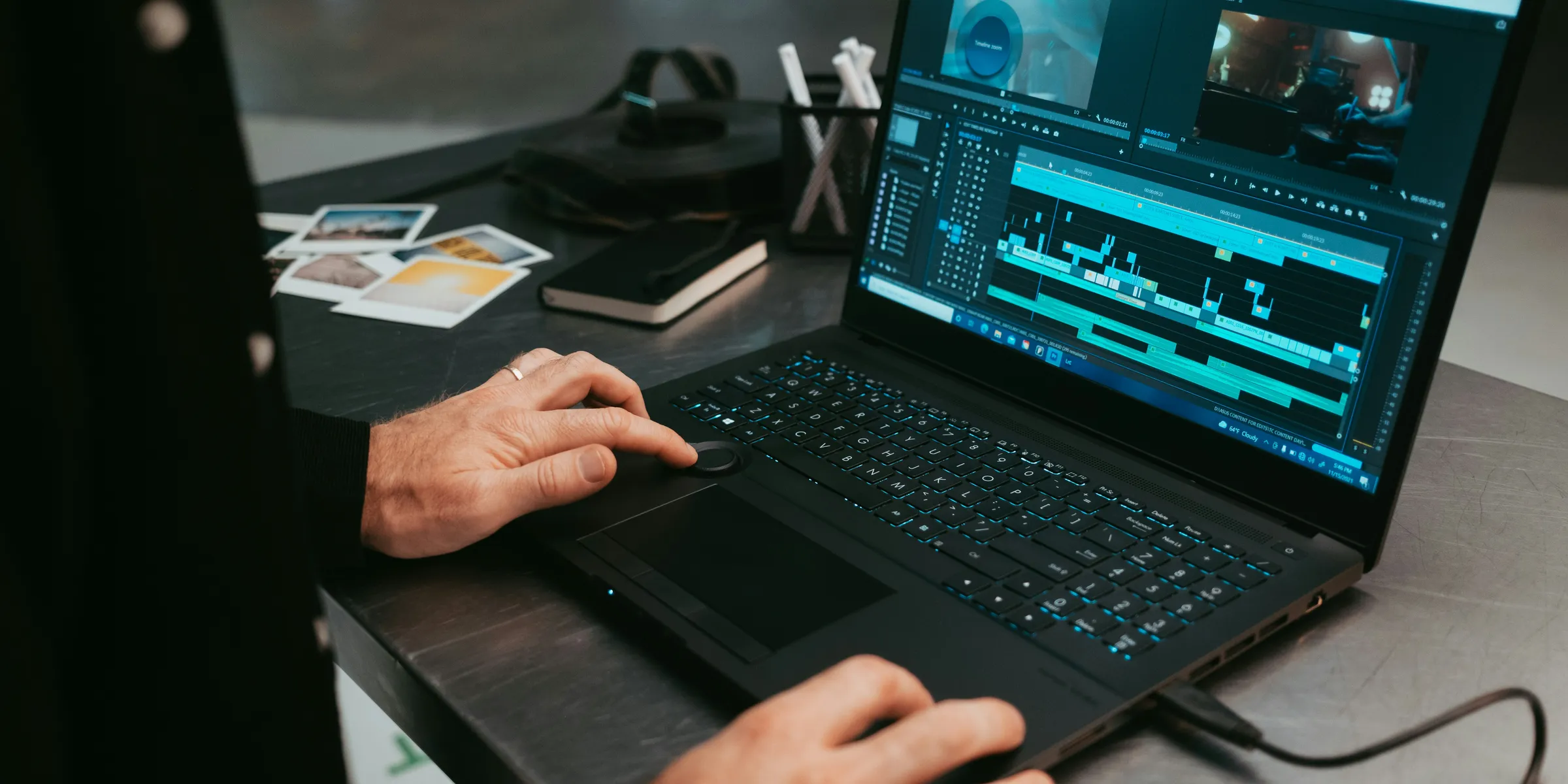 a man sitting at a table using a laptop computer