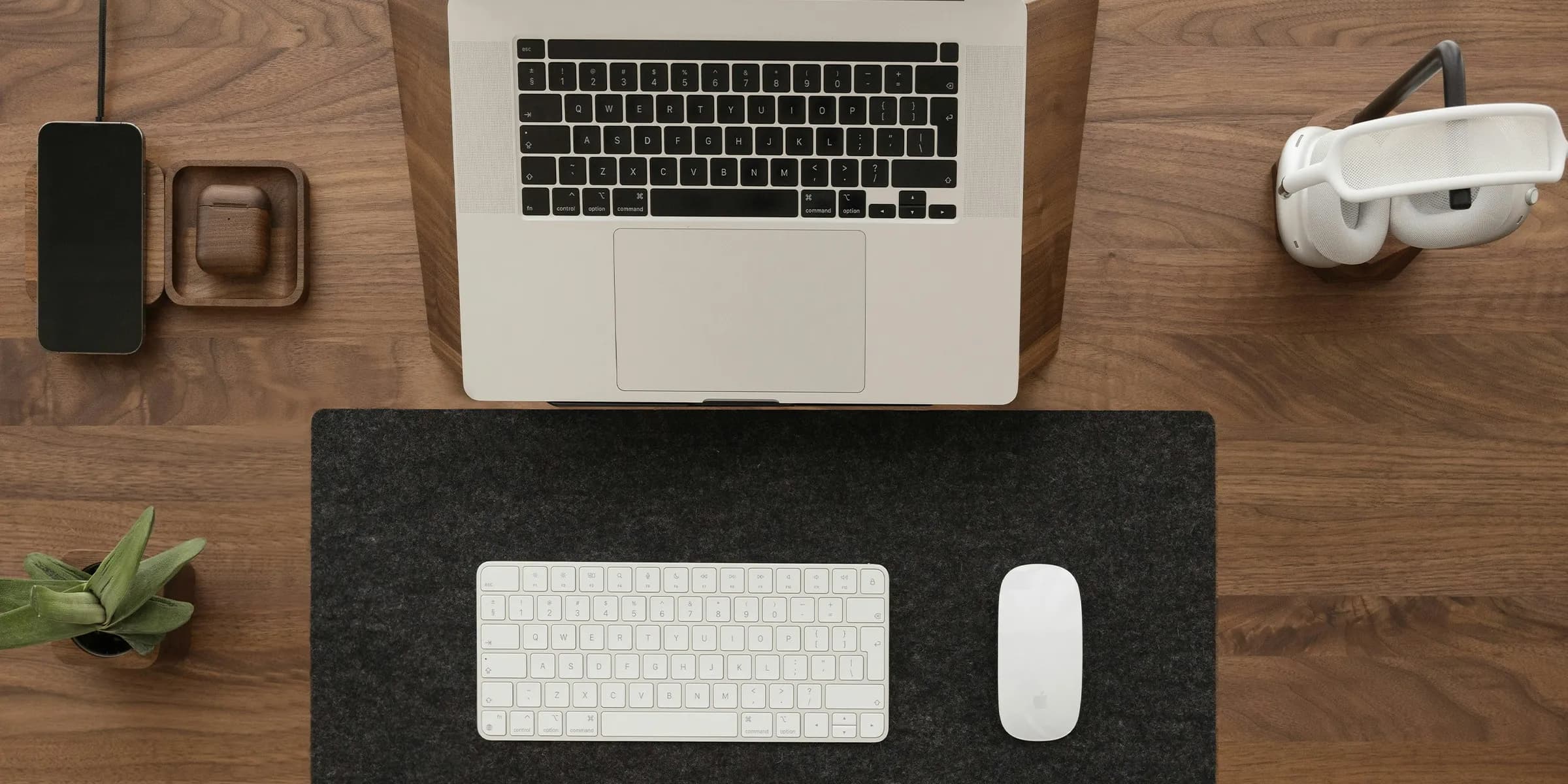 a laptop computer sitting on top of a wooden desk