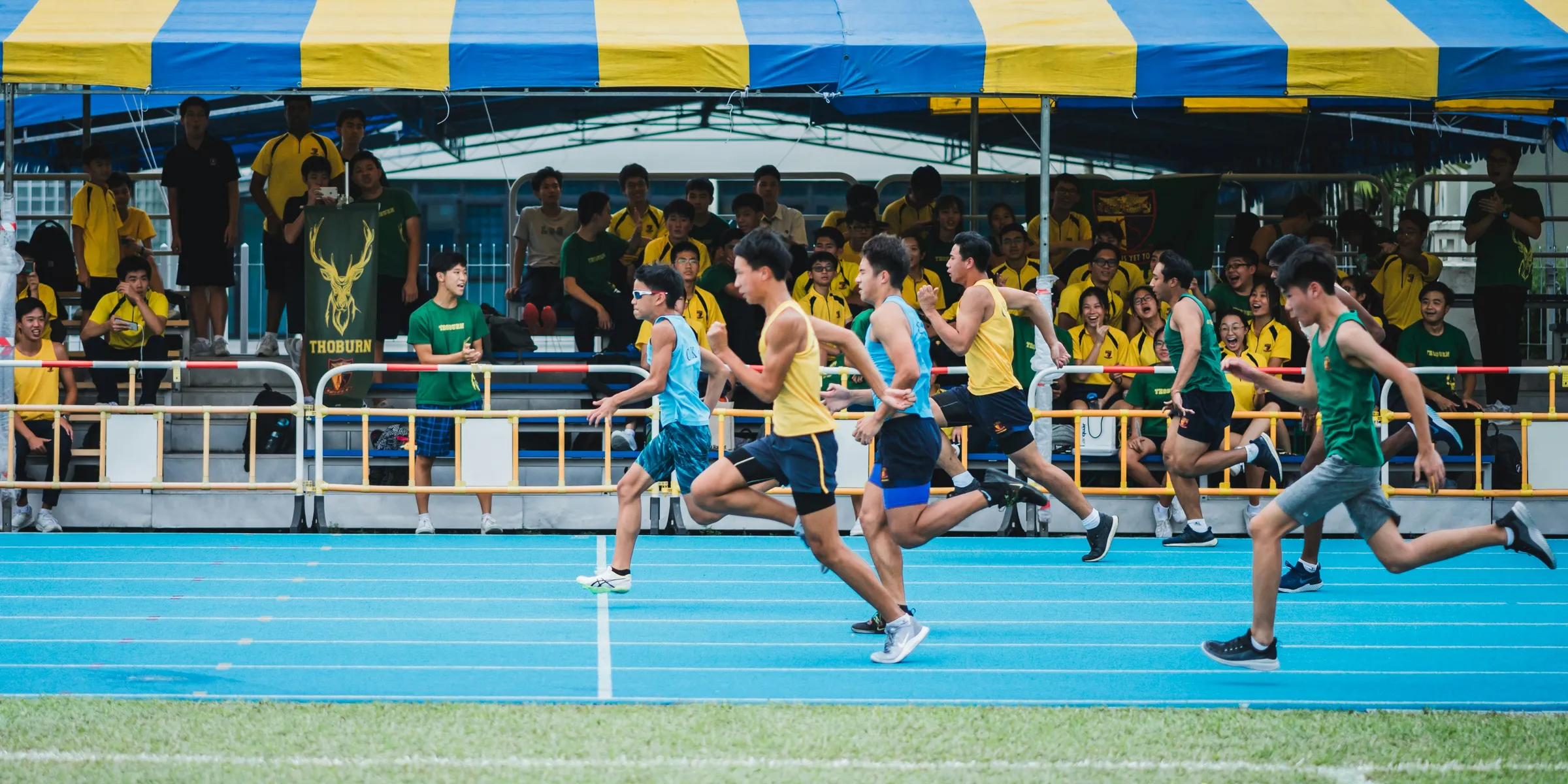group of men running beside watchers under shed