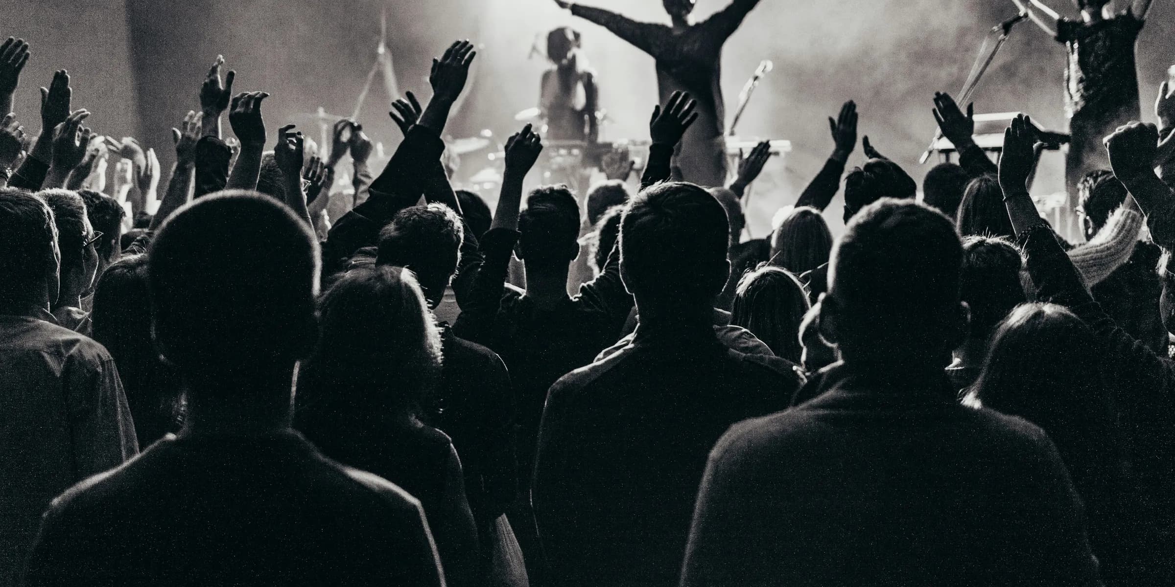 band performing on stage in front of crowd