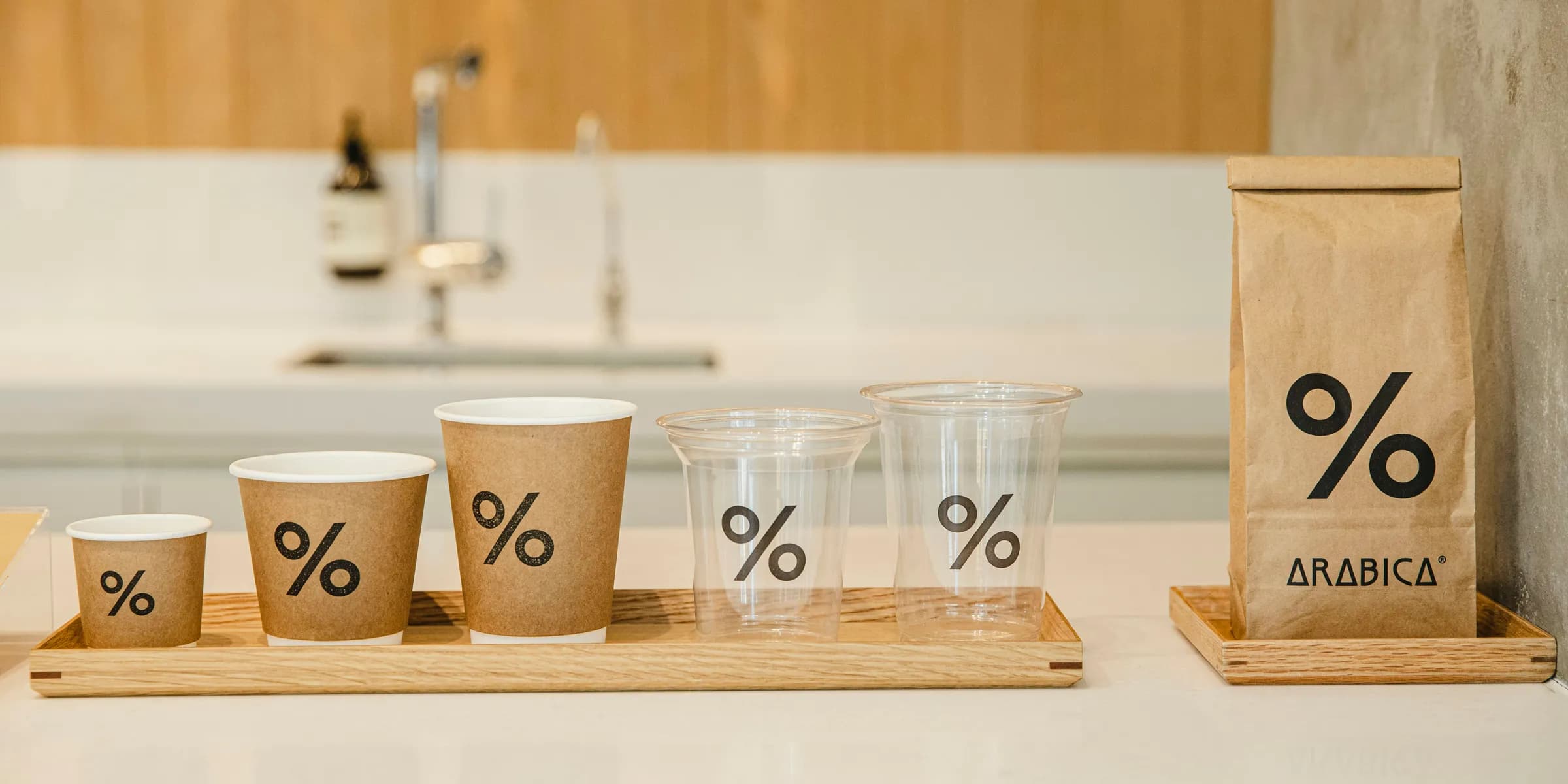 a counter top with cups and a bag on it