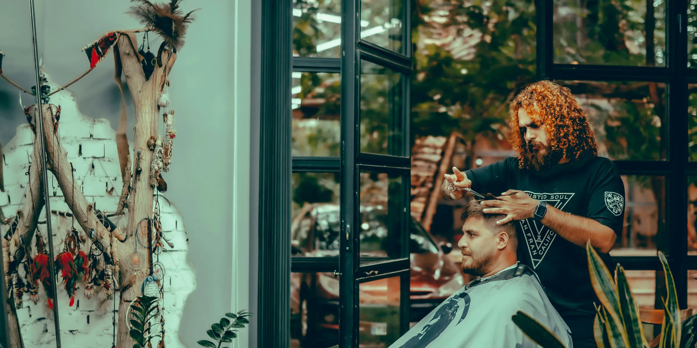 A barber is cutting a client's hair.